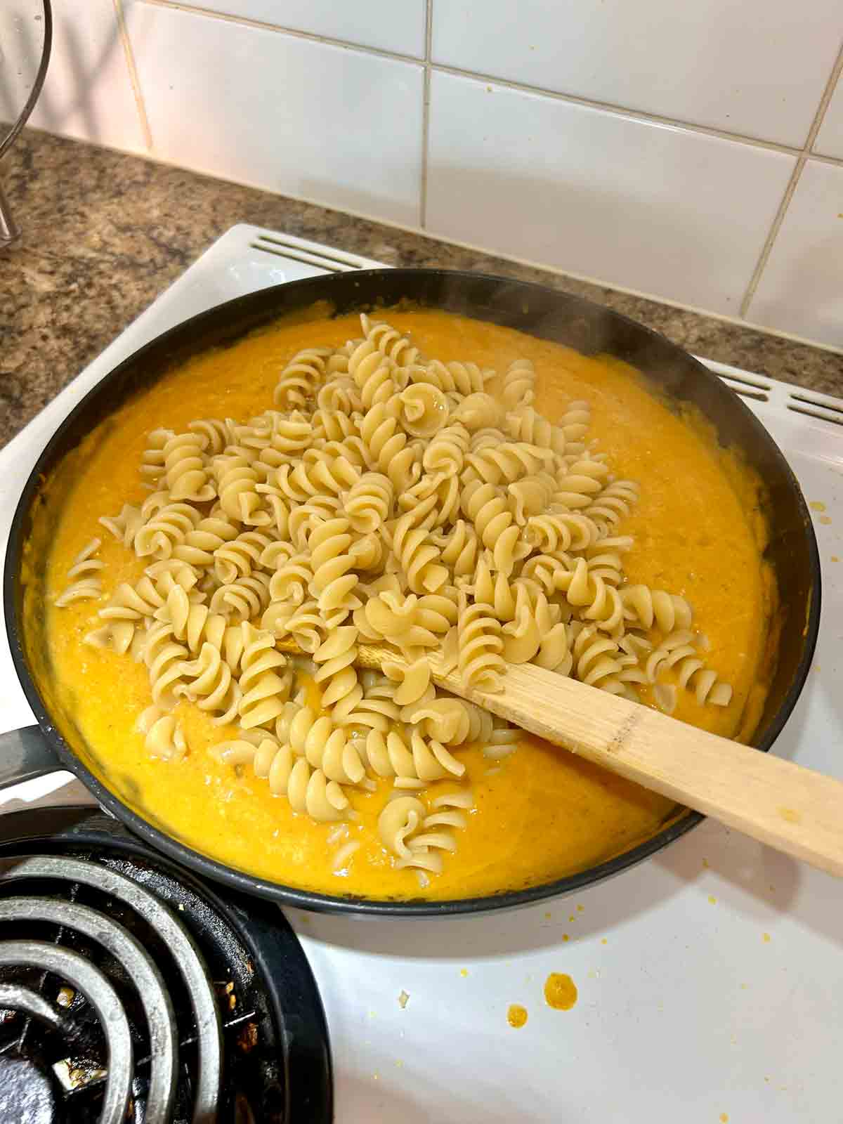 drained pasta added to pan of sauce.