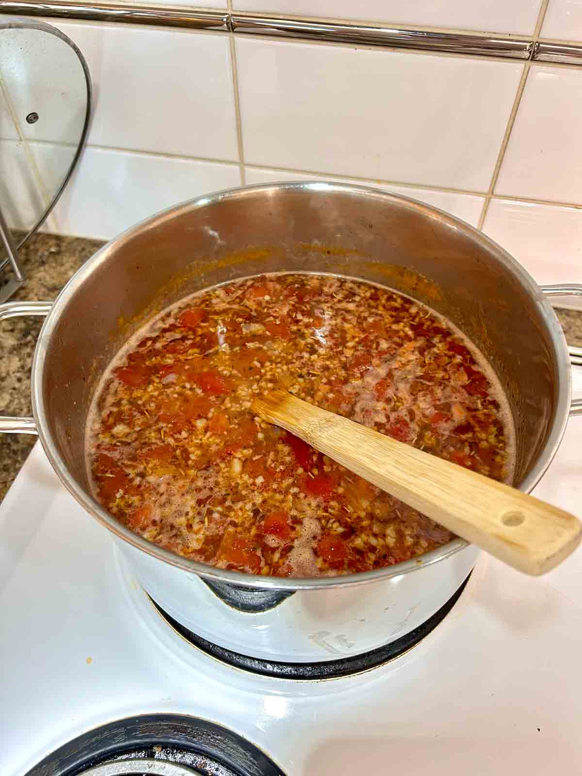 chicken broth and diced tomatoes added to soup.