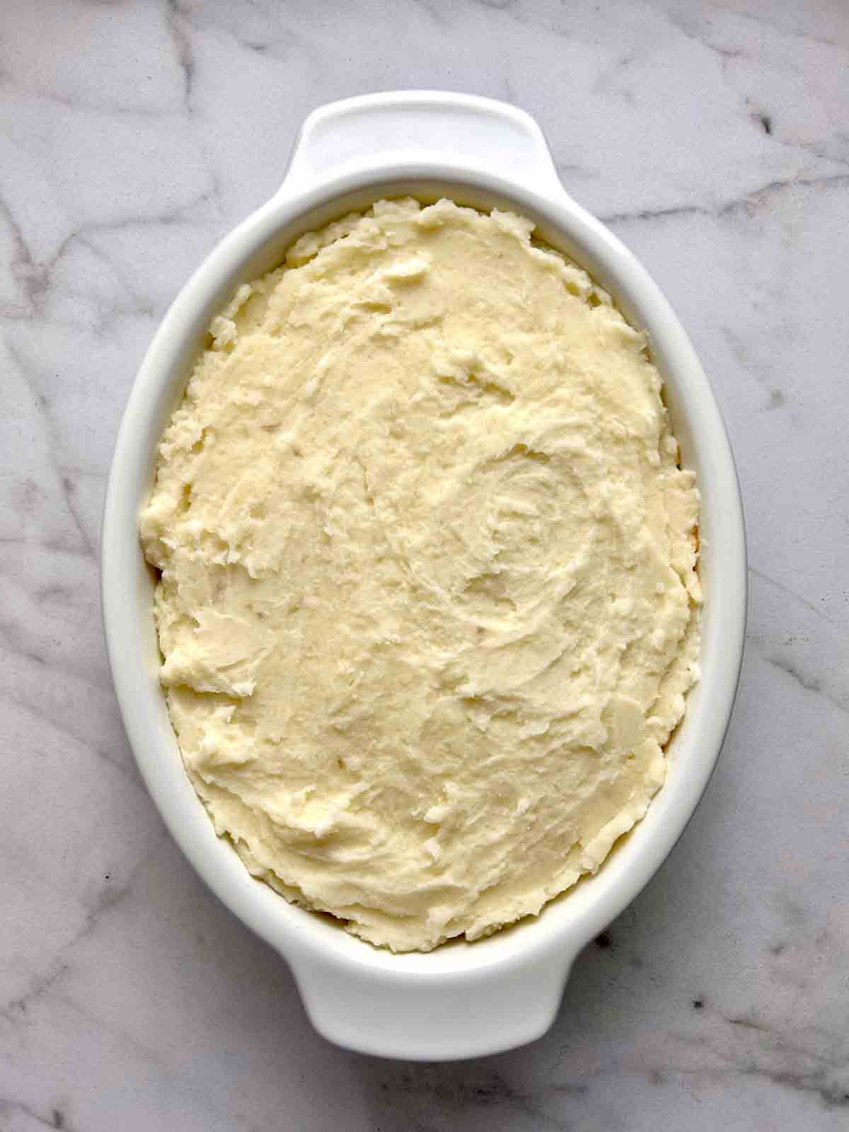 potato layer added on top of meat filling.