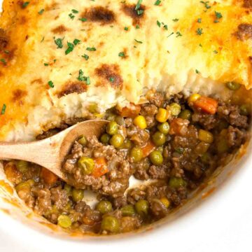 shepherd's pie with chunk taken out of it to show the meat filling.