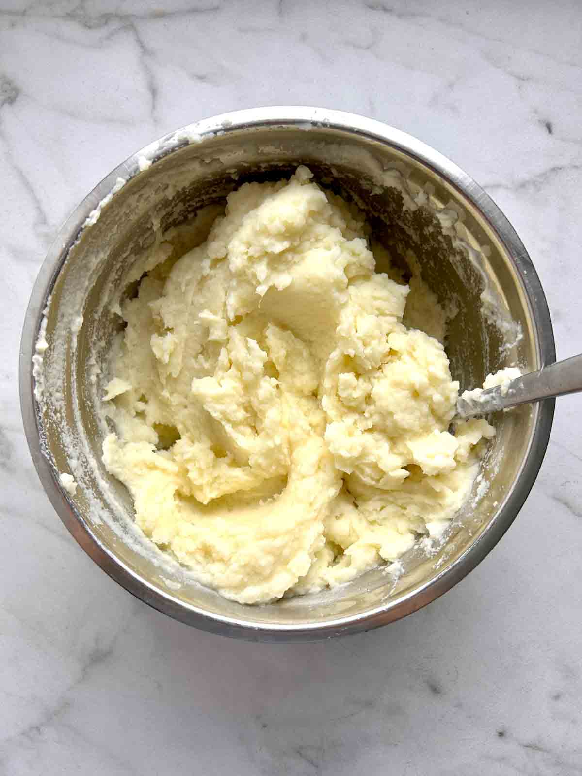 potatoes mashed in bowl with butter and milk.