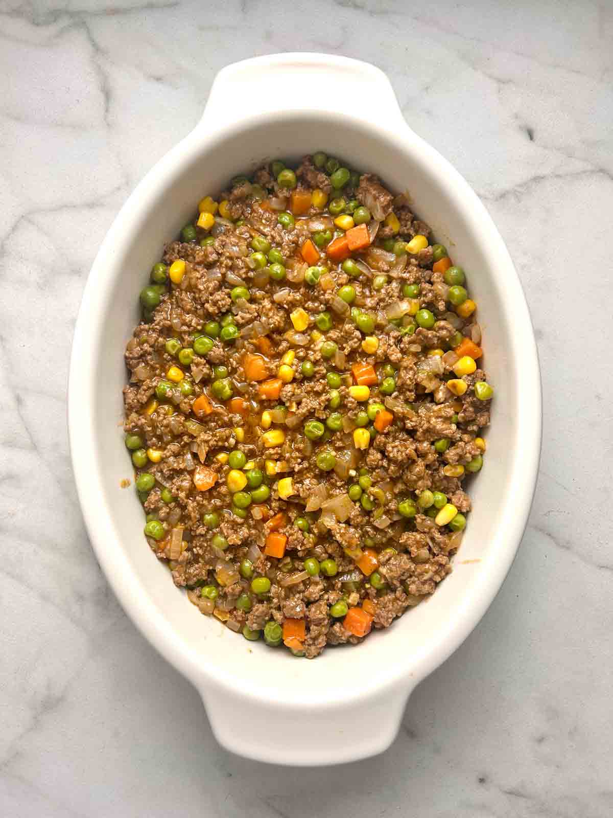 meat layer added to baking dish.