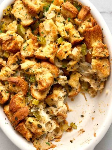 stuffing in casserole dish with portion scooped out of it.