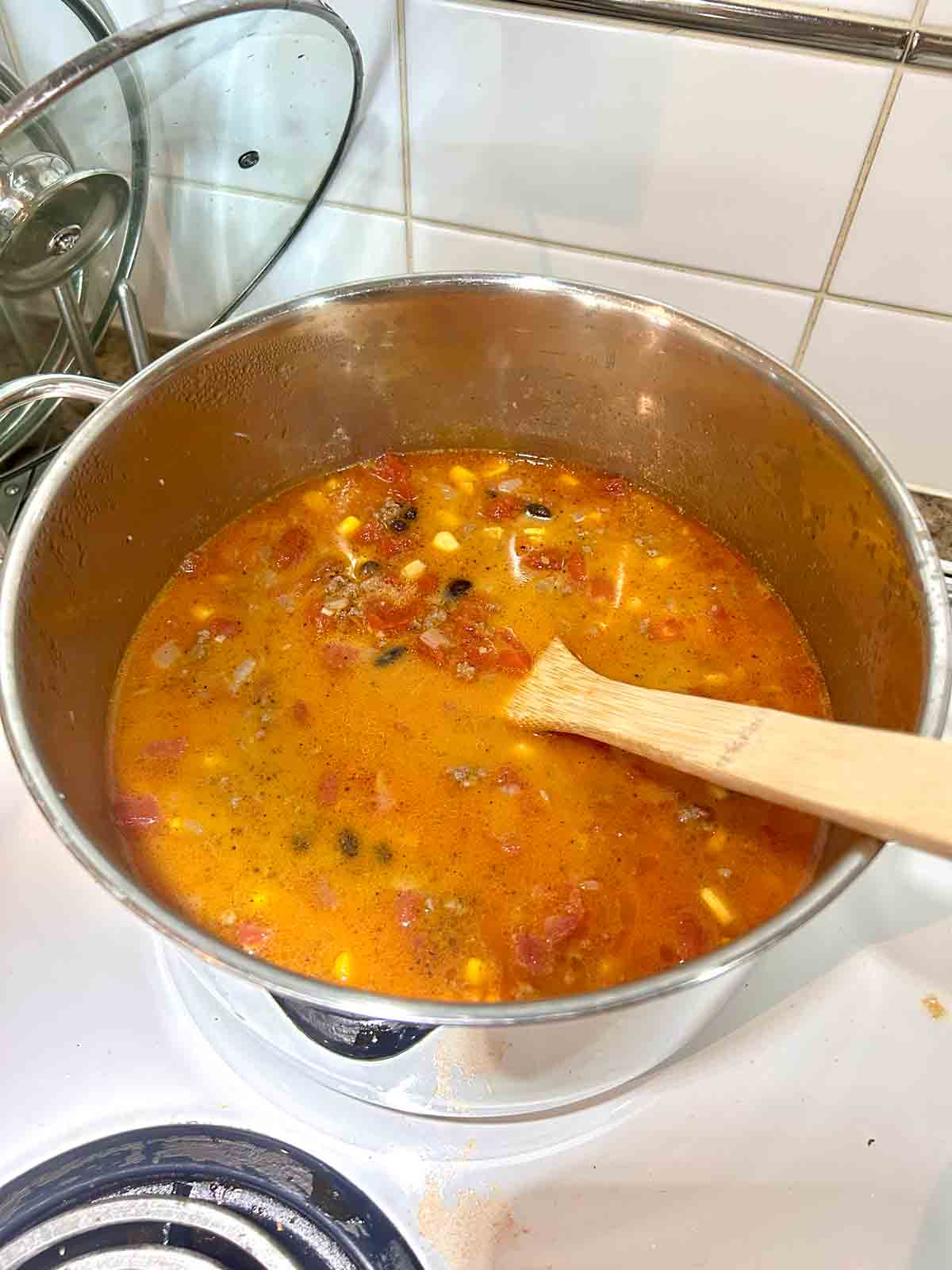 beans, corn, and heavy cream stirred into soup.