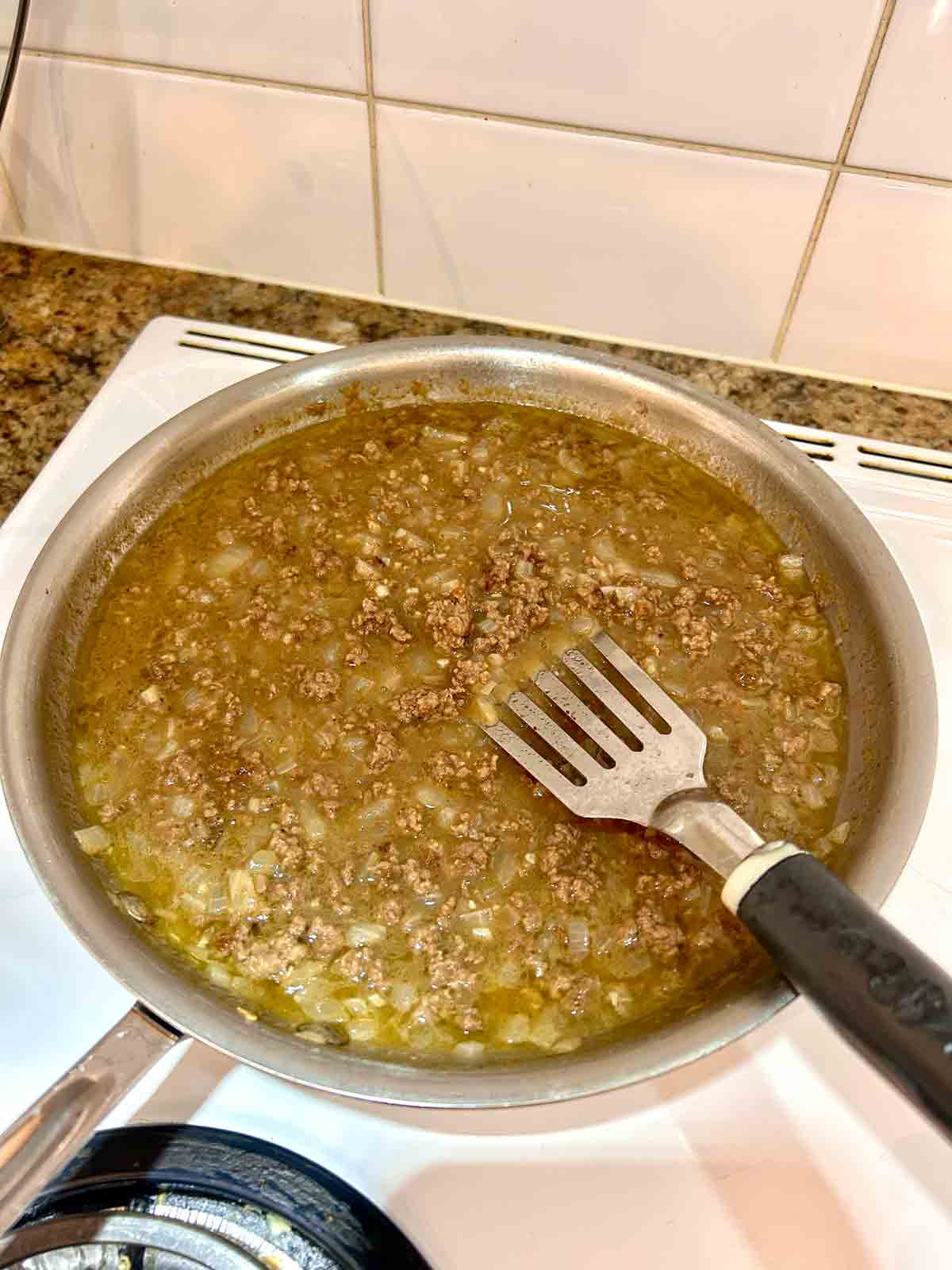 broth added to beef mixture and simmering.