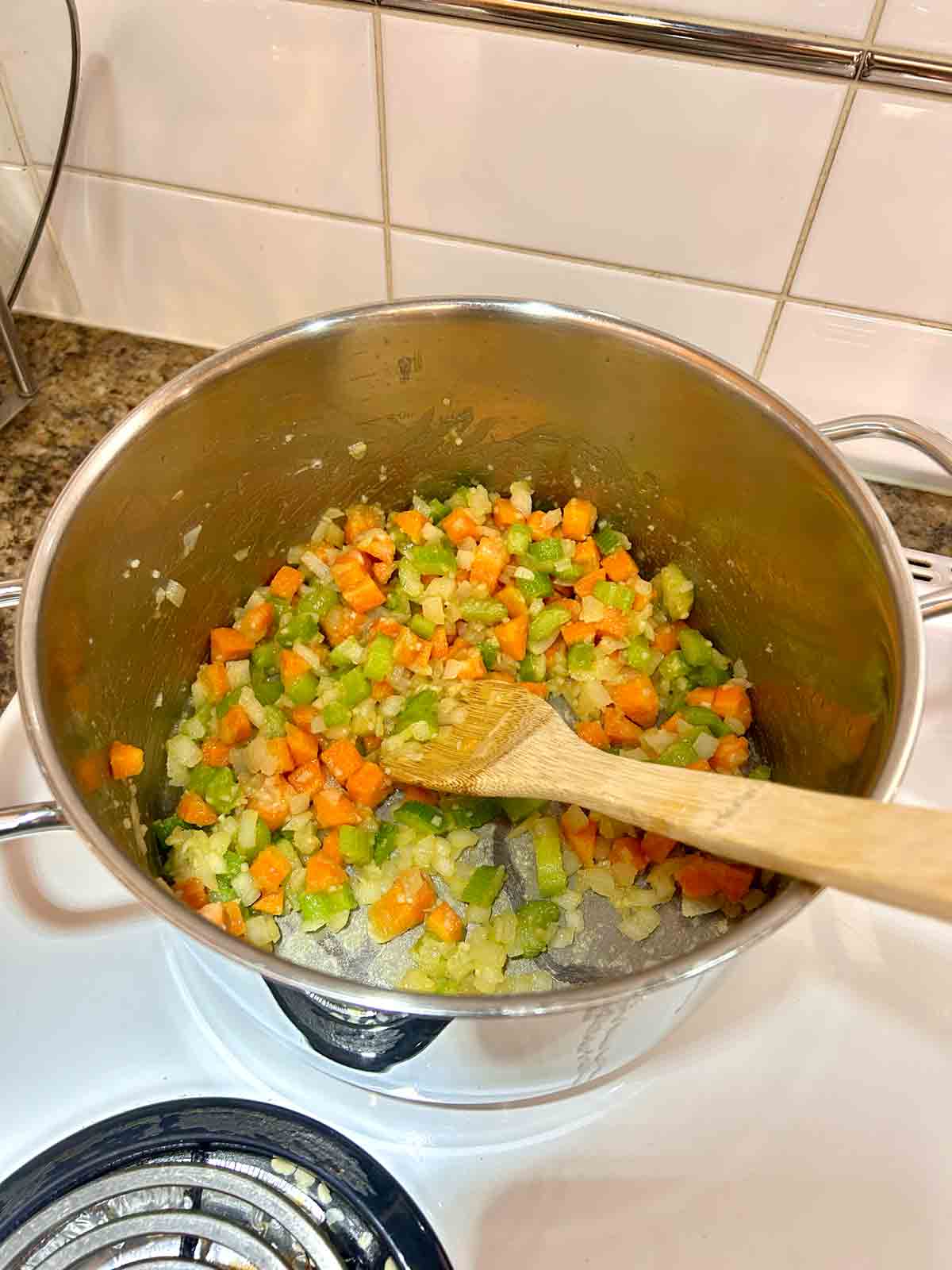 flour stirred into veggies in pot.