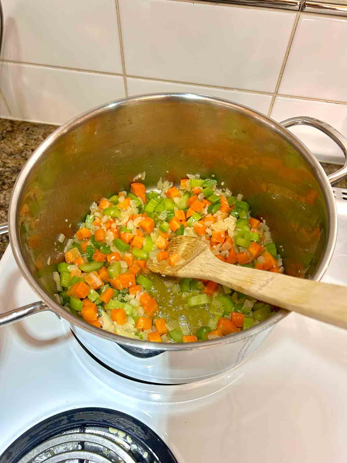 vegetables being sautรฉed in pot.