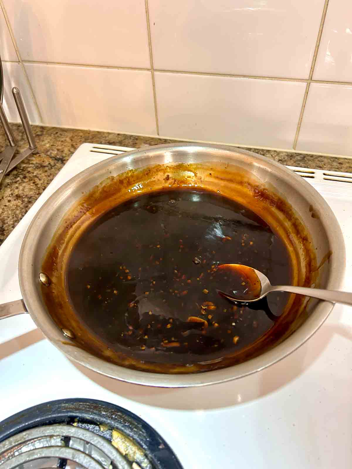 sauce simmering and thickened in pan.