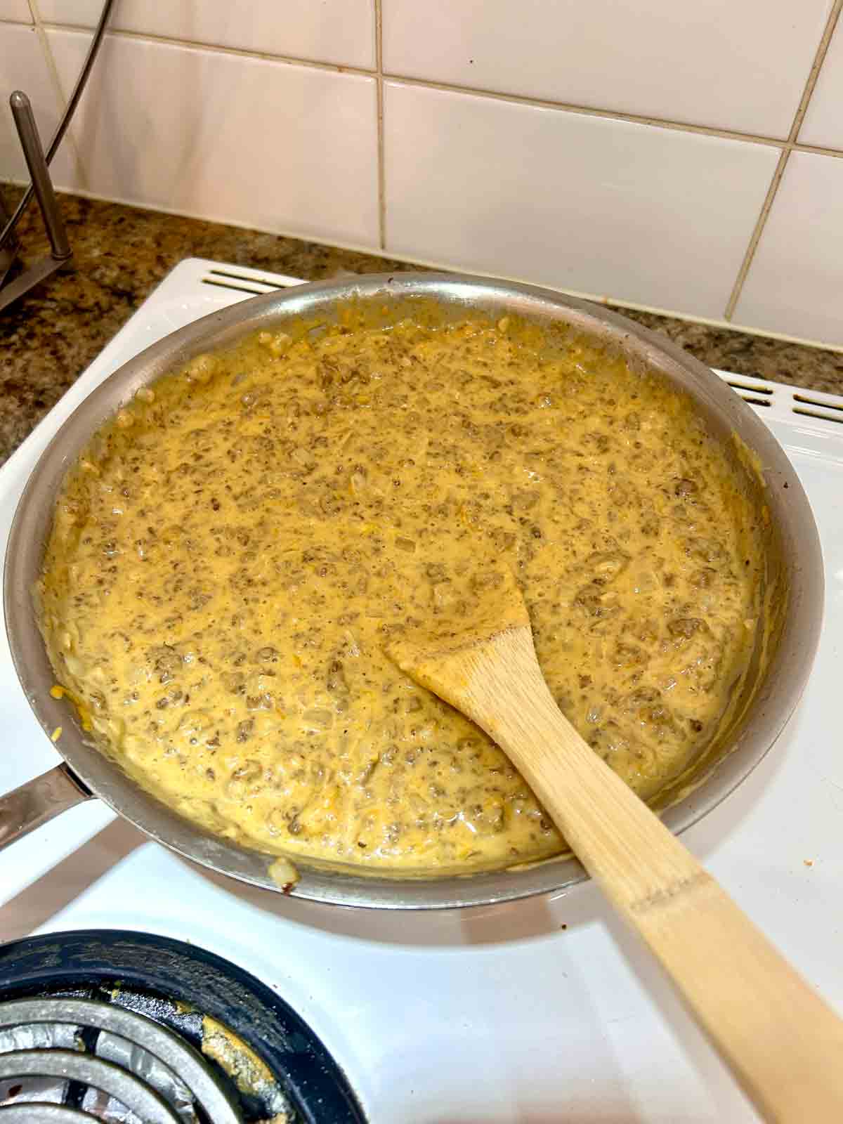 cheddar cheese stirred into sauce.