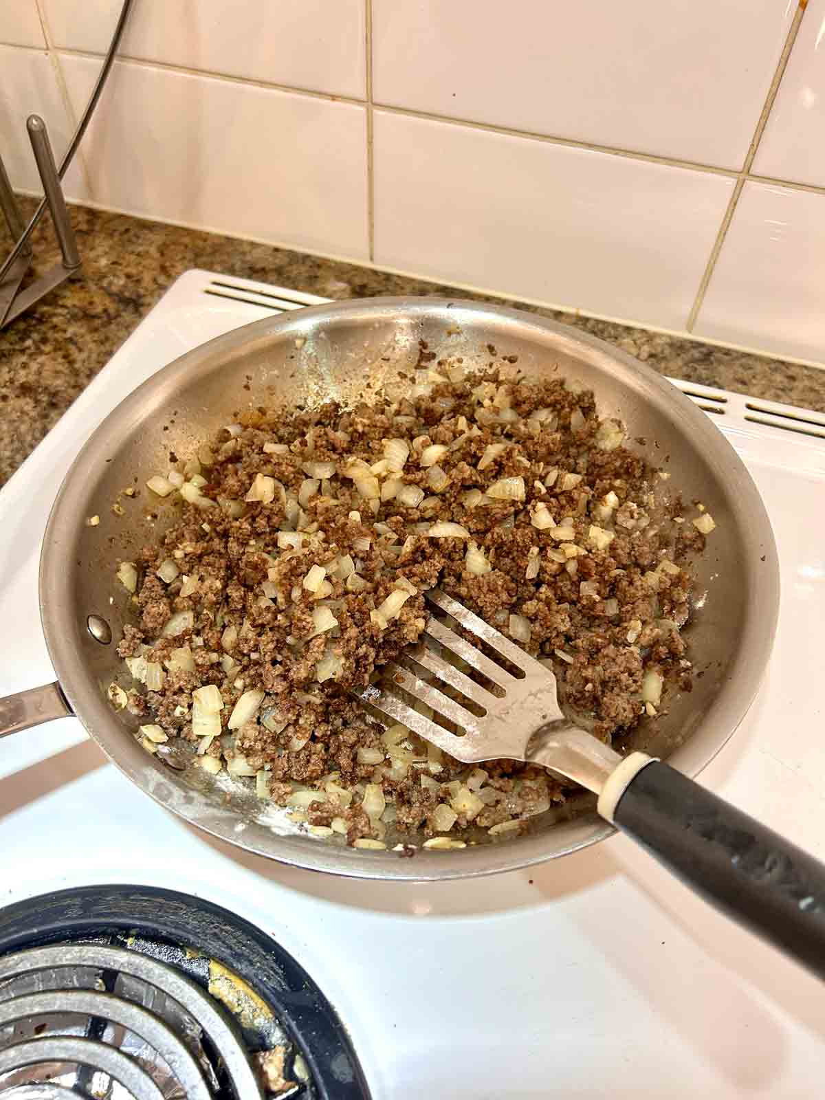 flour stirred into beef and onion mixture in pan.