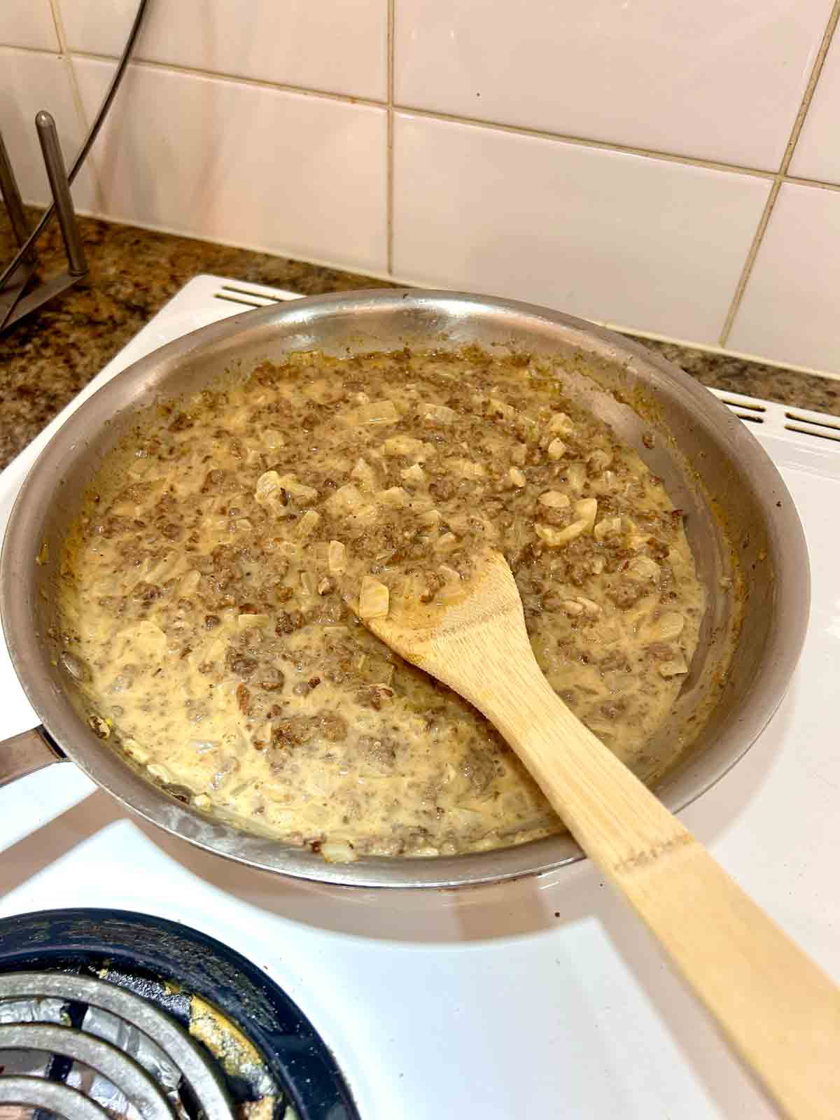 stock, cream, and paprika stirred into beef; simmering for few minutes.