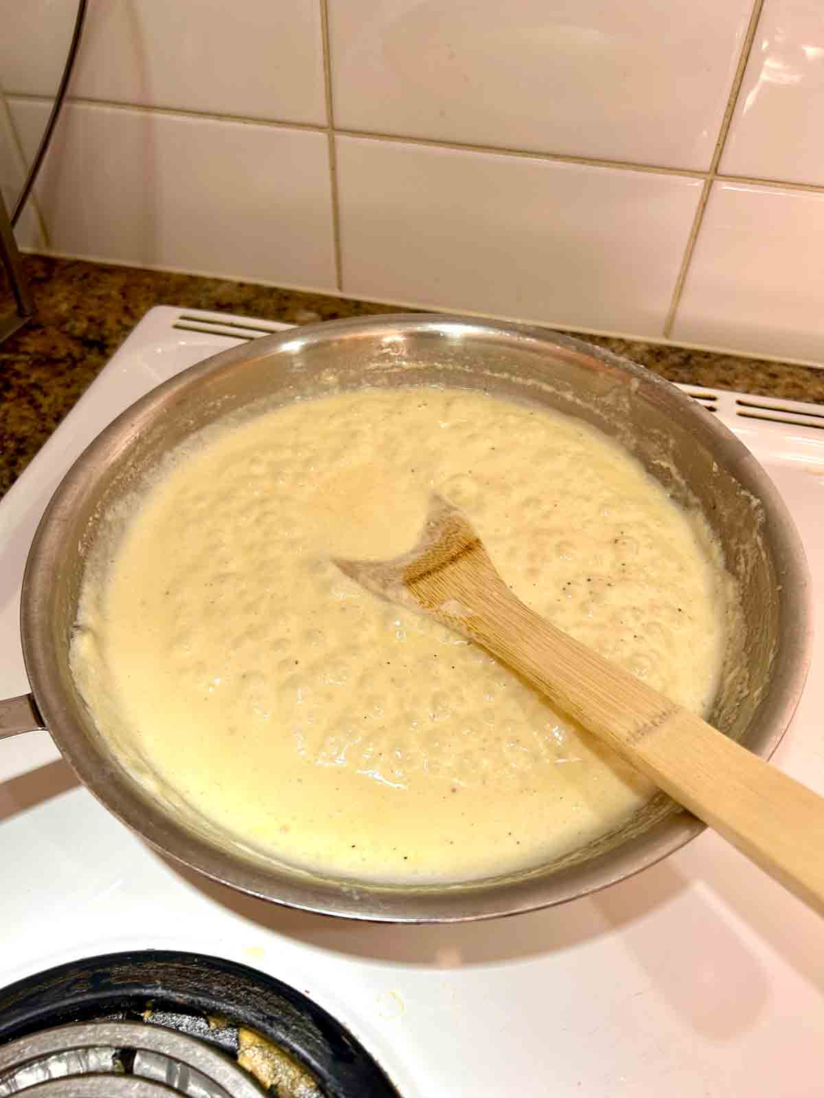 cream sauce simmering in skillet.