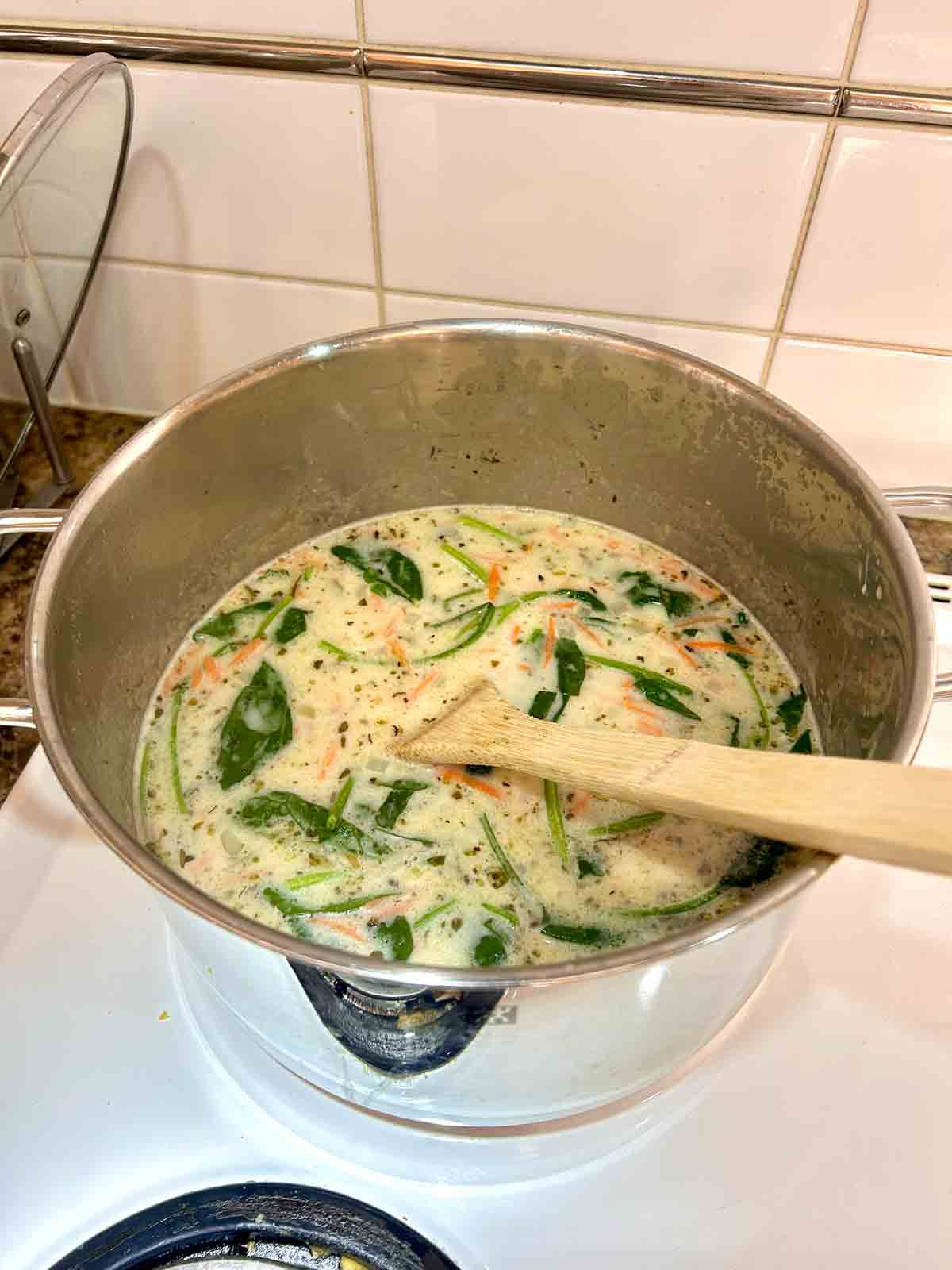 cream, spinach, and carrots added to pot.