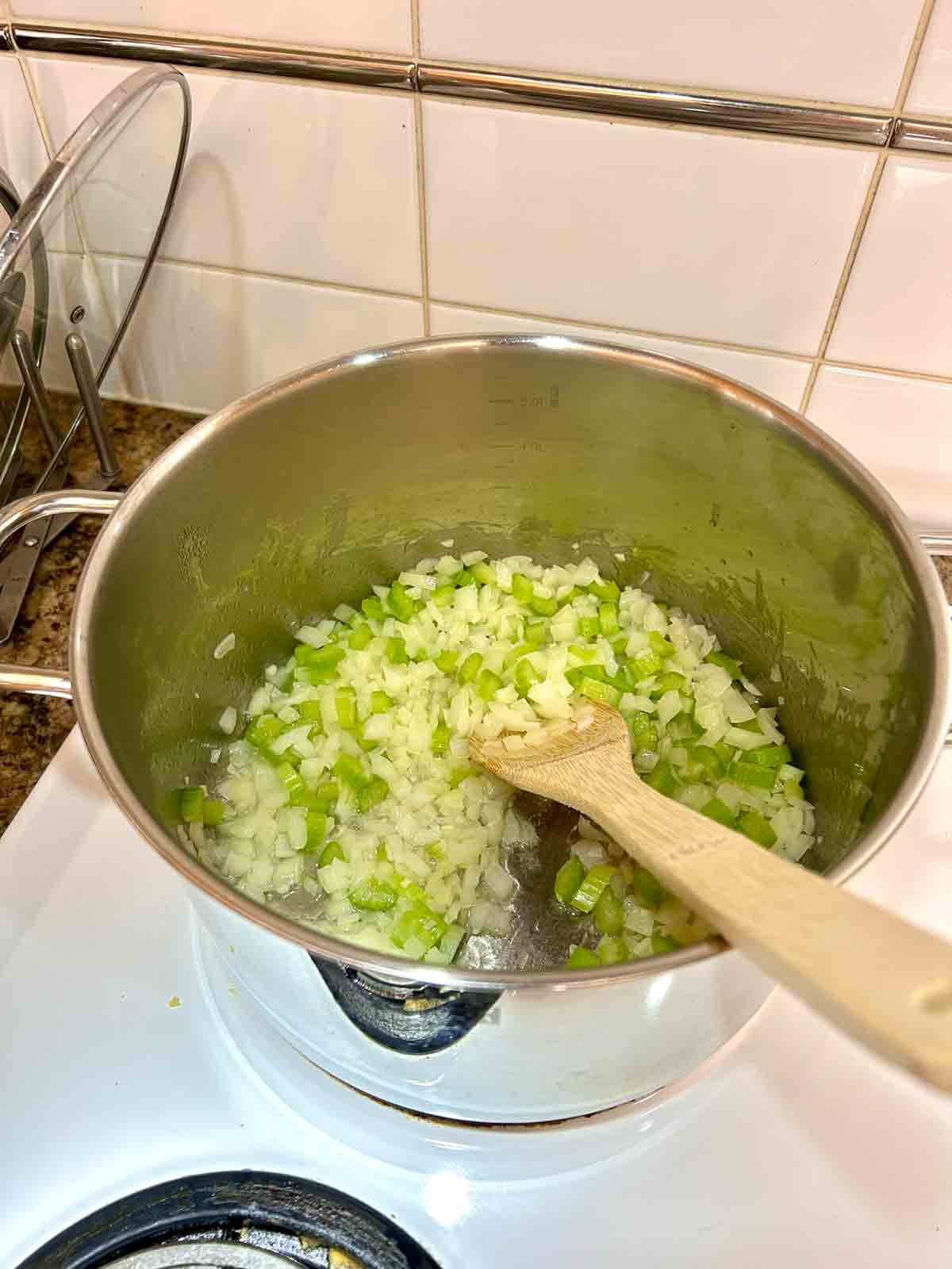 onions, garlic, and celery cooked in pot.