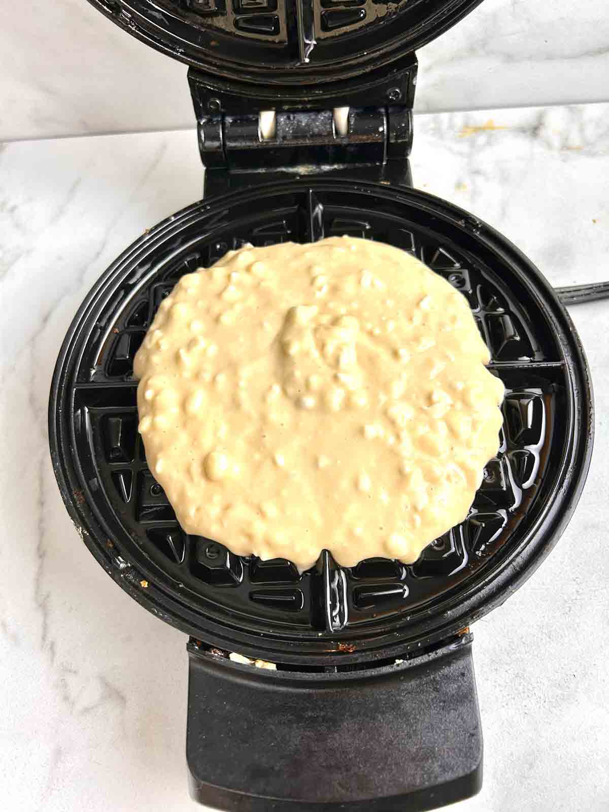 batter scooped into waffle iron.