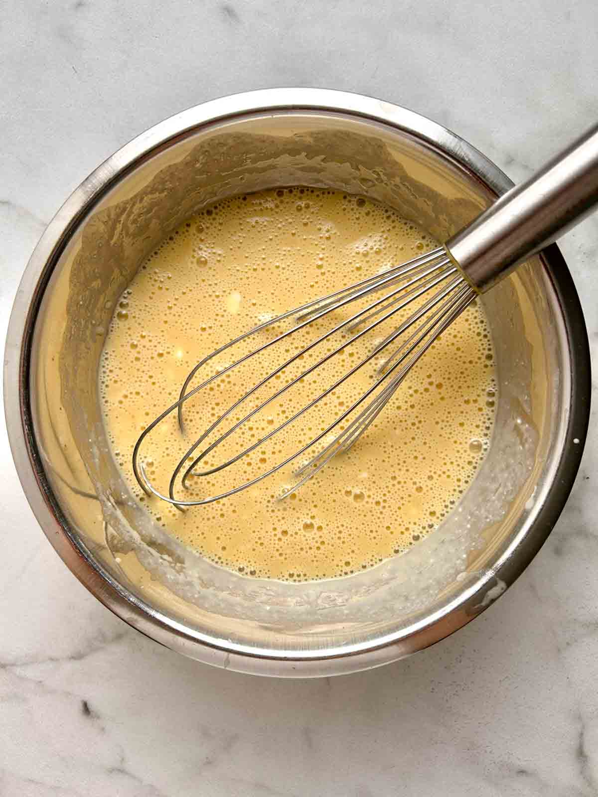wet ingredients whisked in bowl.