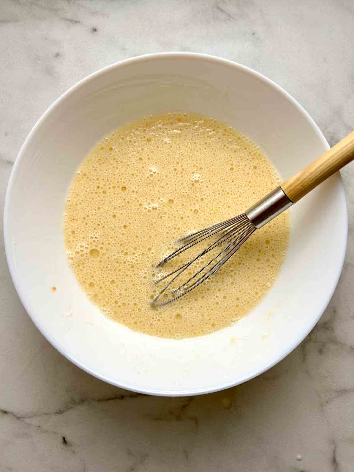 wet ingredients whisked in bowl.