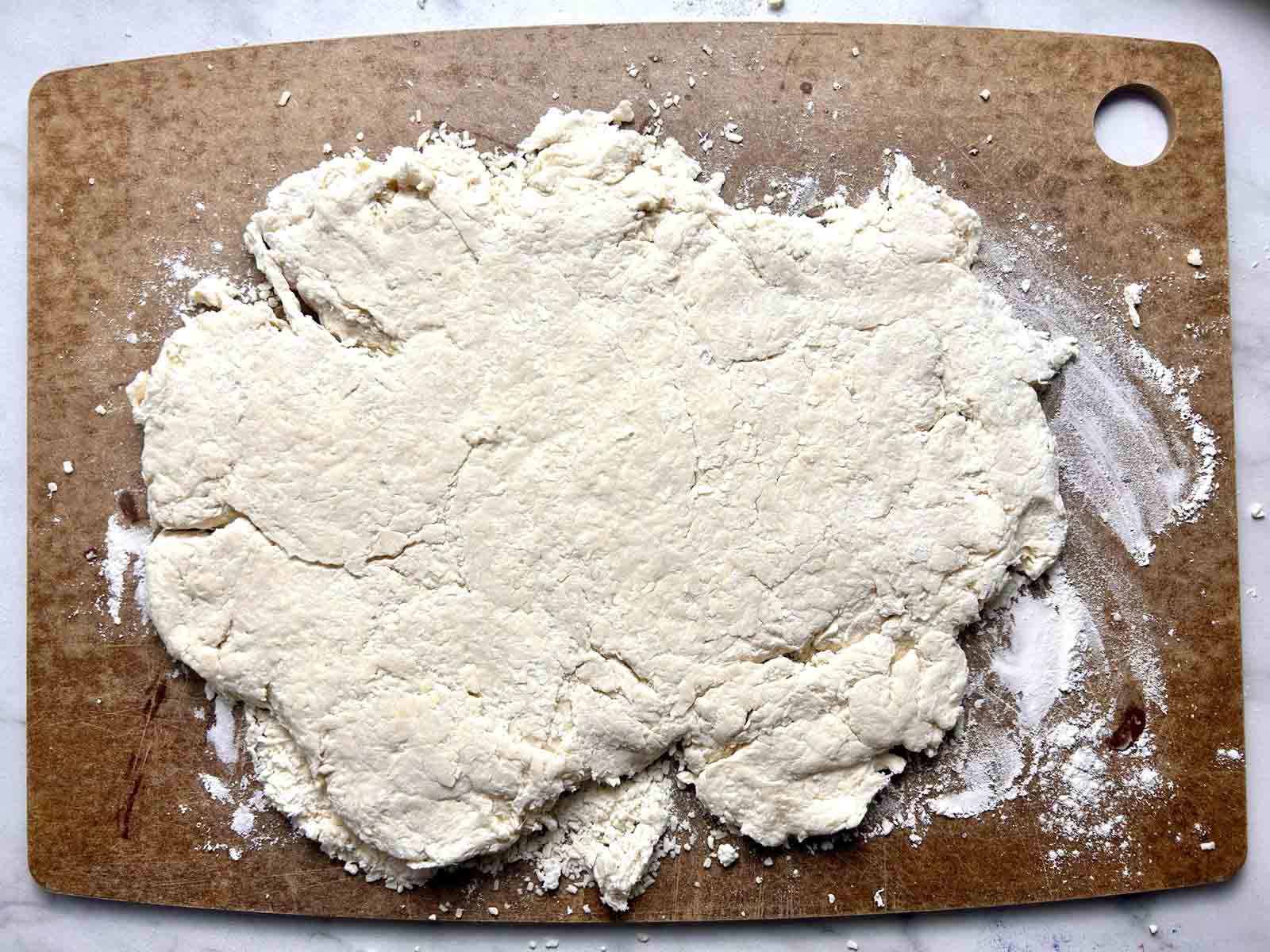 dough rolled out on cutting board.