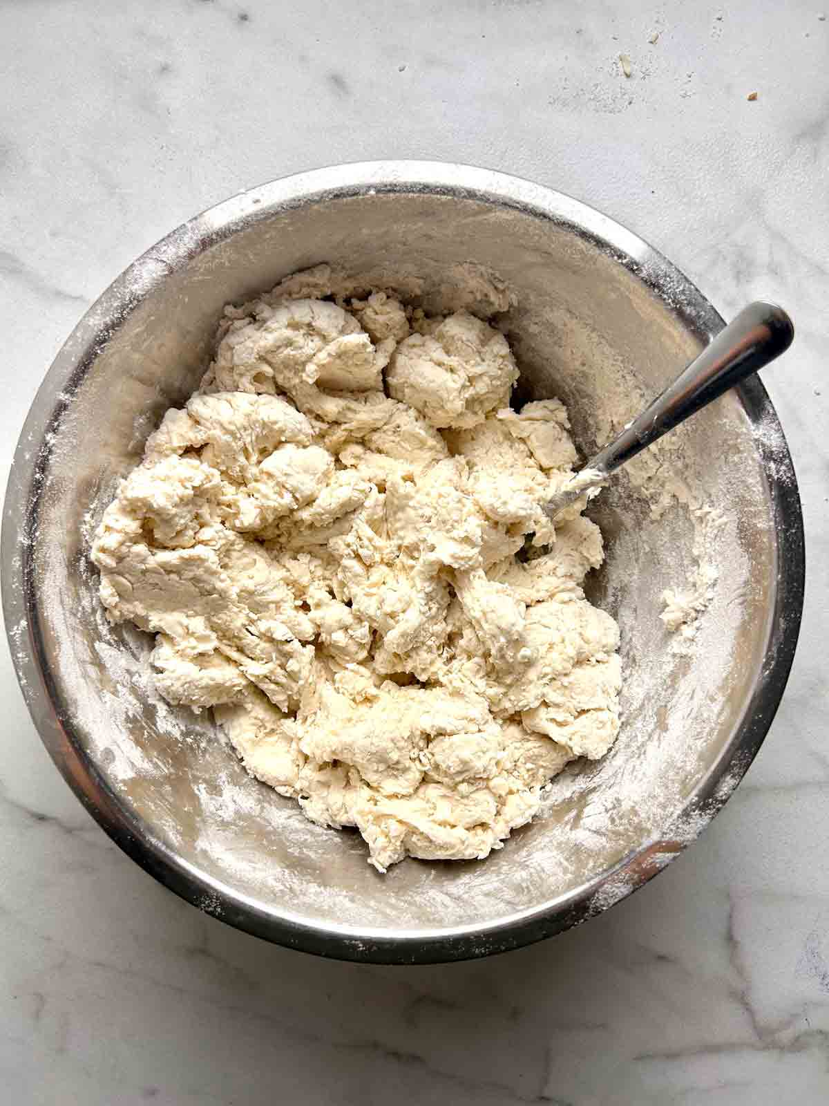 dough just barely mixed together in bowl.