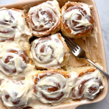 close up of cinnamon rolls in baking dish.