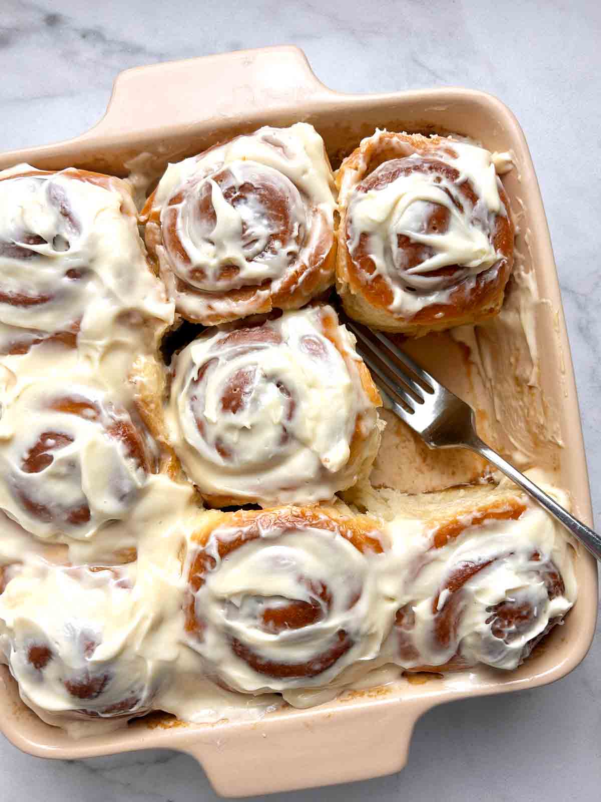 close up of cinnamon rolls in baking dish.
