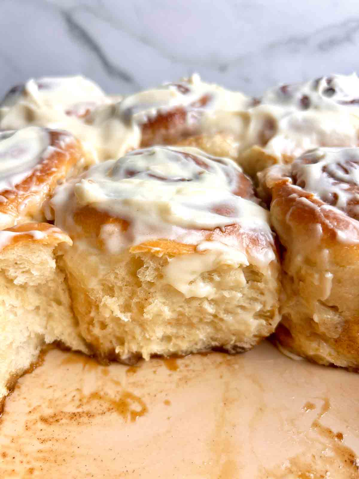 close up of cinnamon rolls in baking dish.