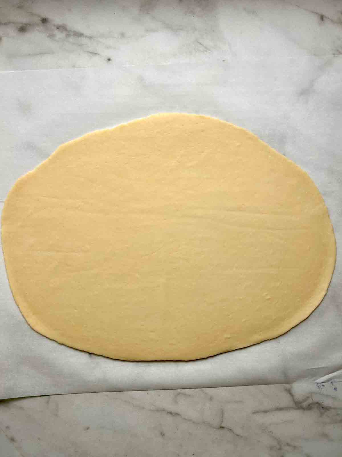 dough rolled to 1/16 inch thick on parchment.