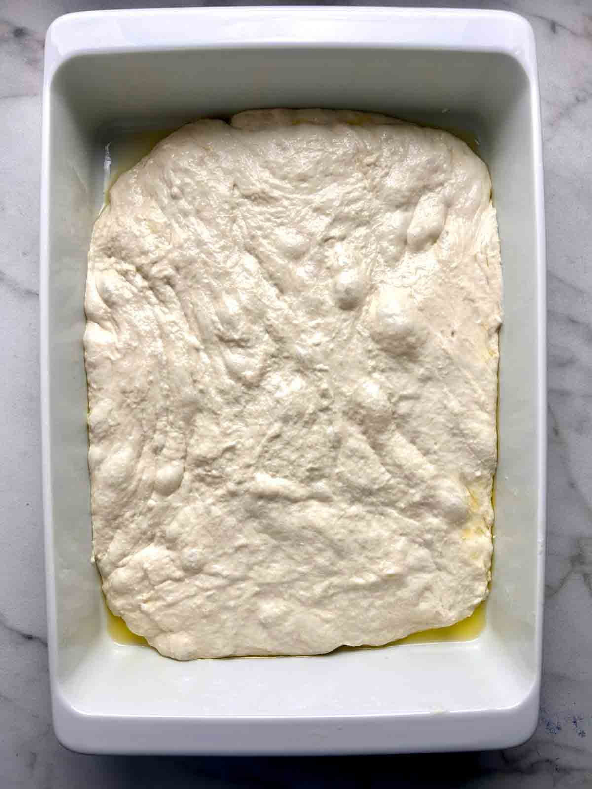 dough stretched to edges of baking dish.