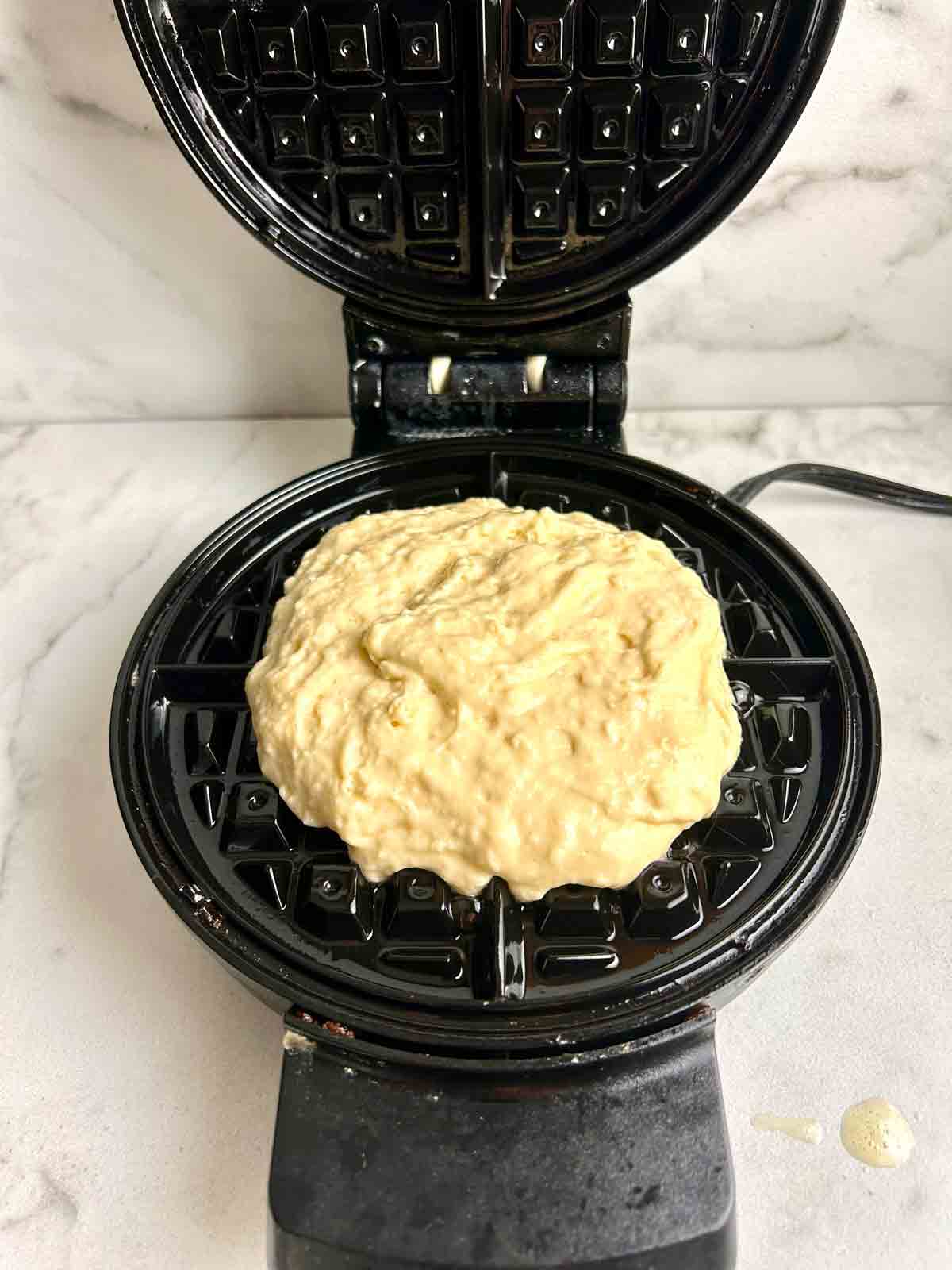 batter scooped into waffle iron.