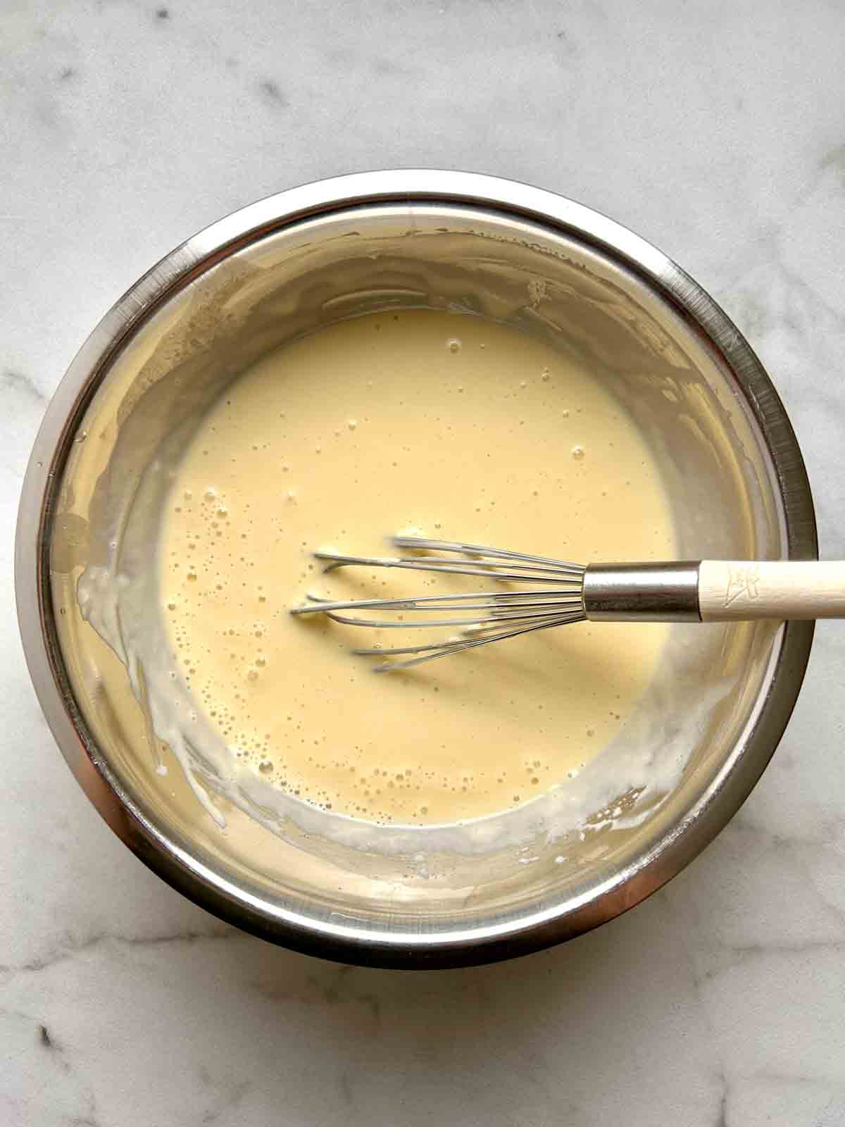 wet ingredients whisked in bowl.