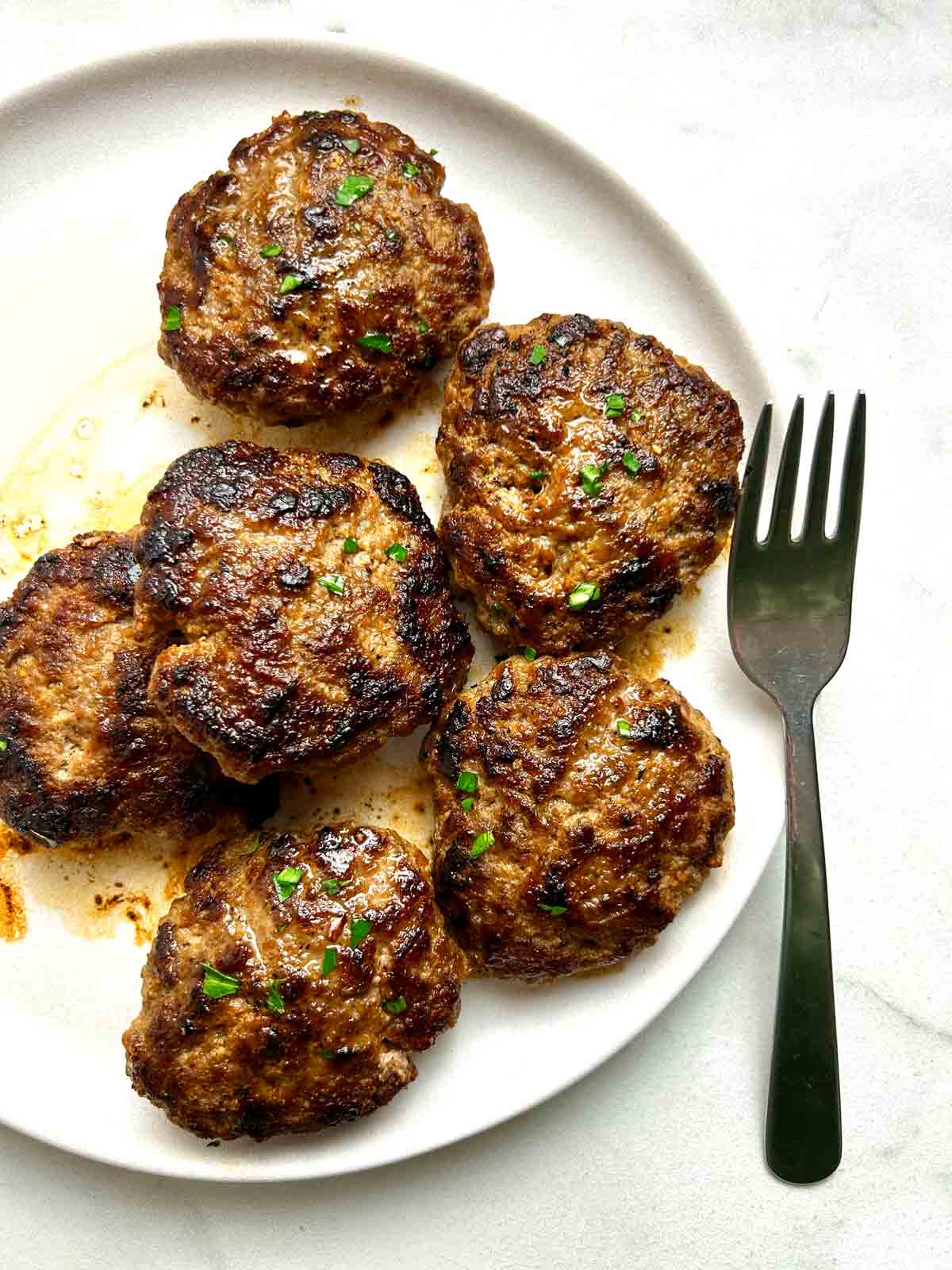 overhead shot of breakfast sausages on plate.