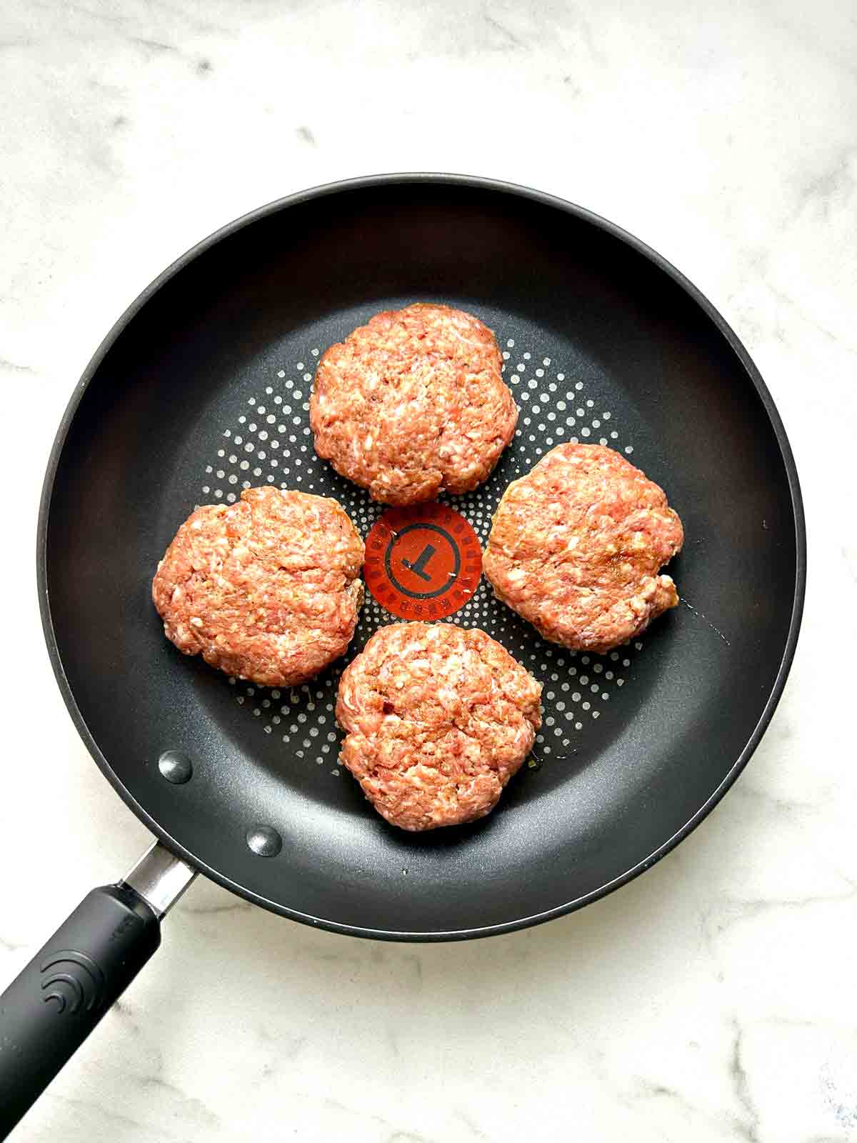 sausage patties in pan.