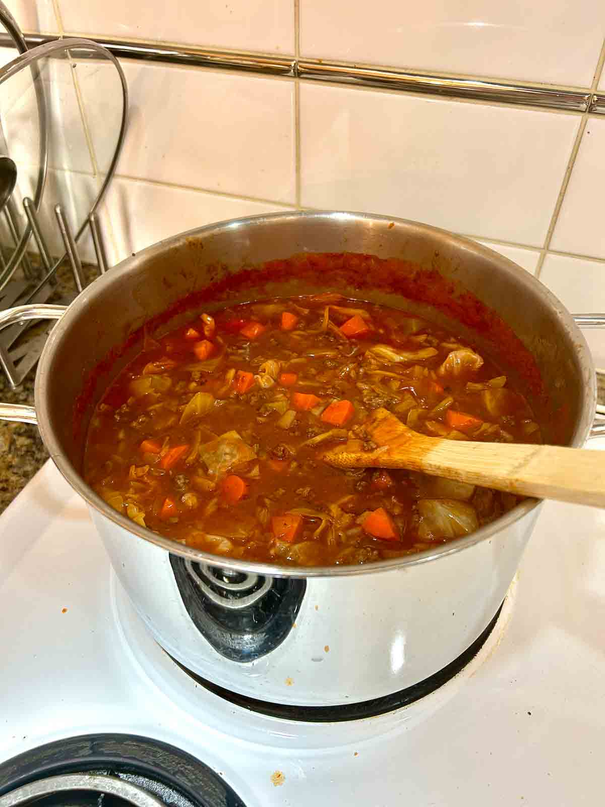 broth, tomato sauce, and rice added to pot and simmered.