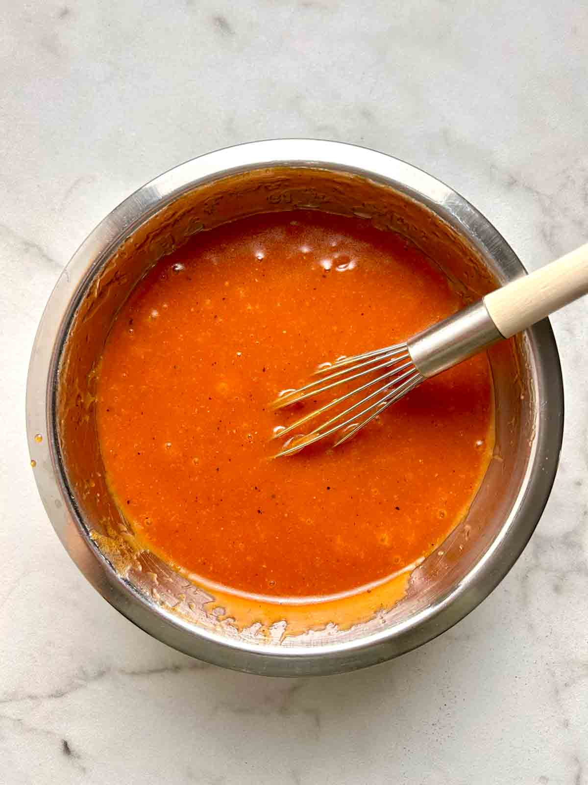 ingredients being whisked in bowl.