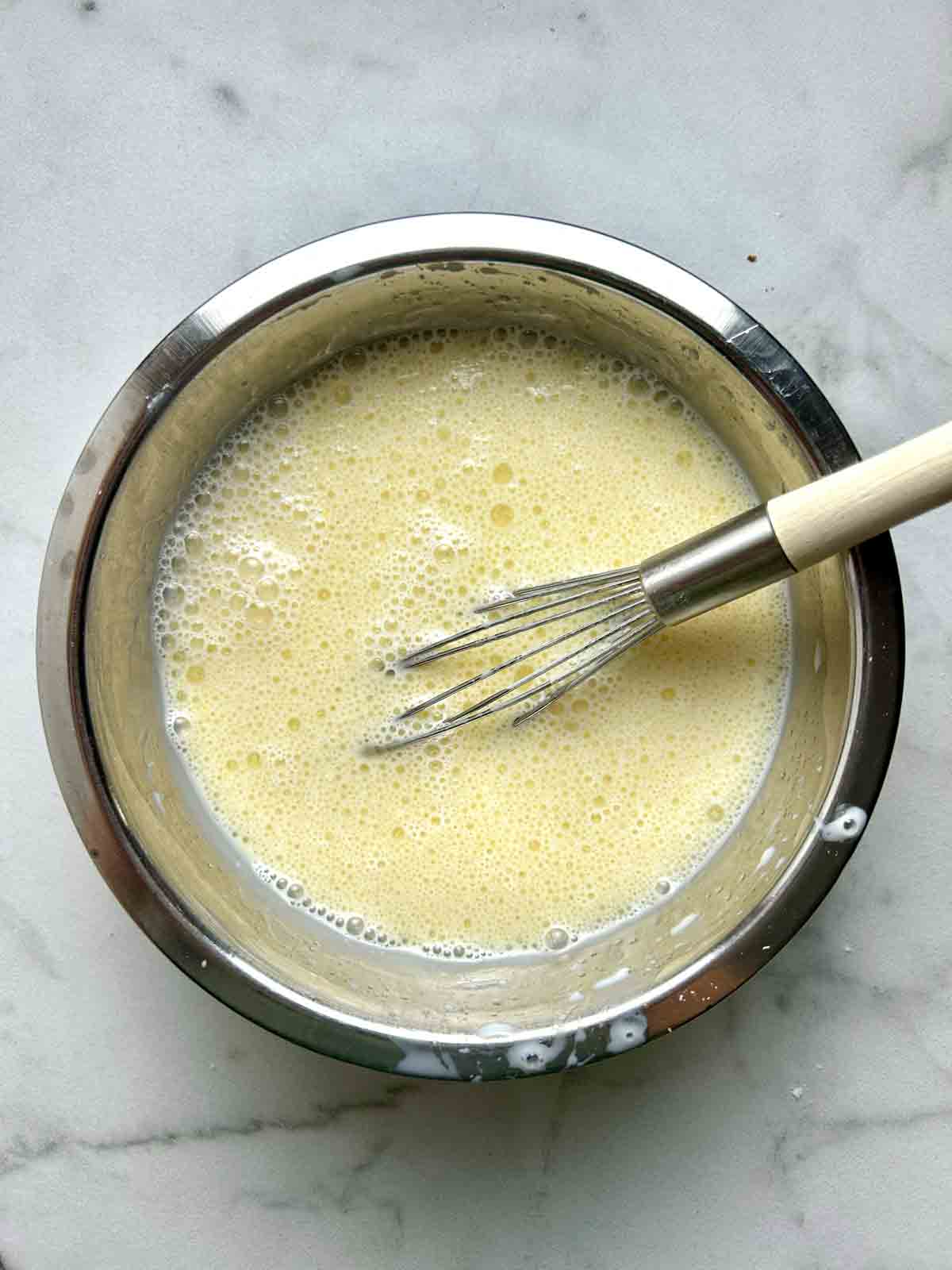 egg mixture whisked in bowl.