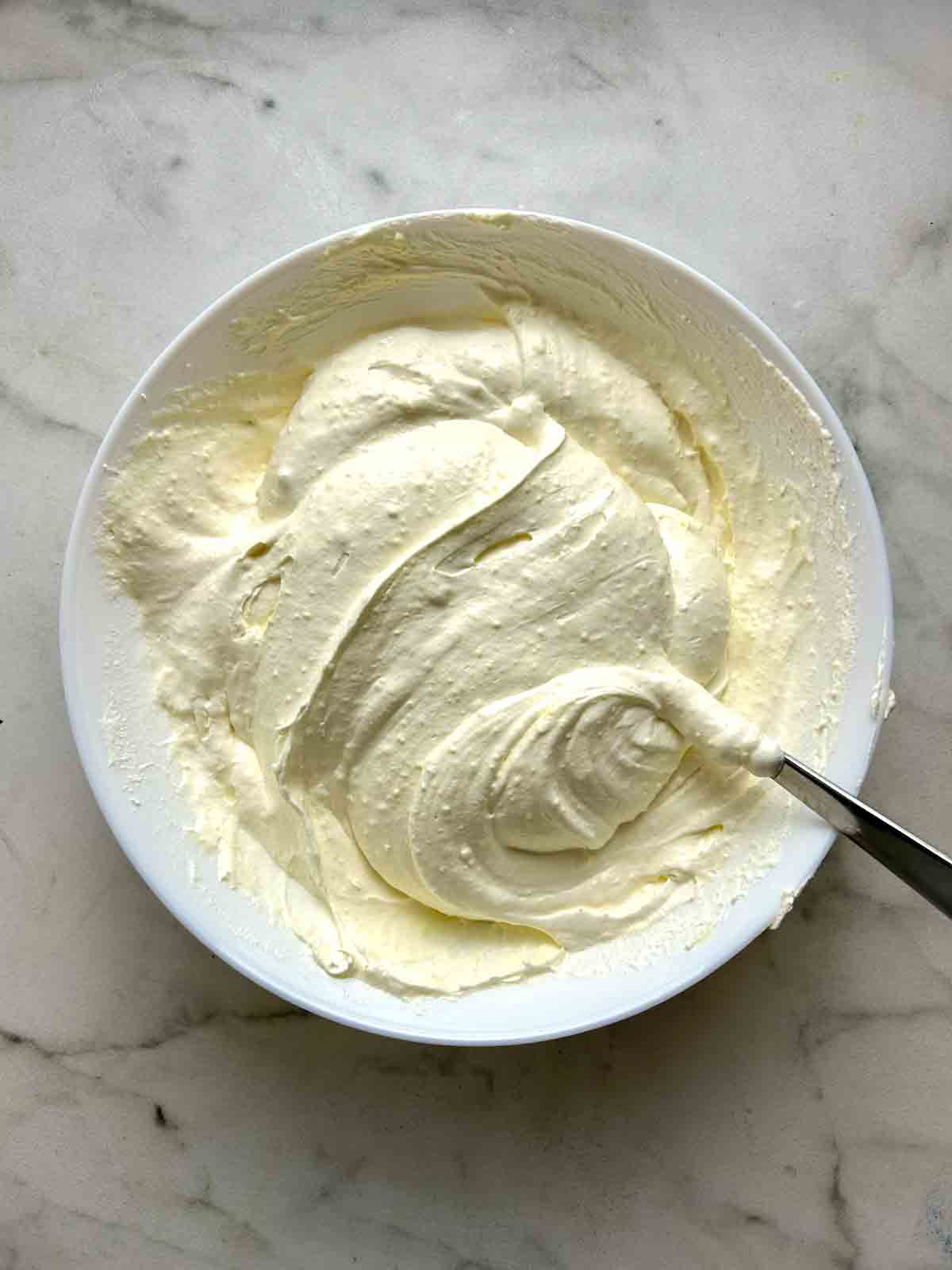 Cool whip folded into vanilla pudding.