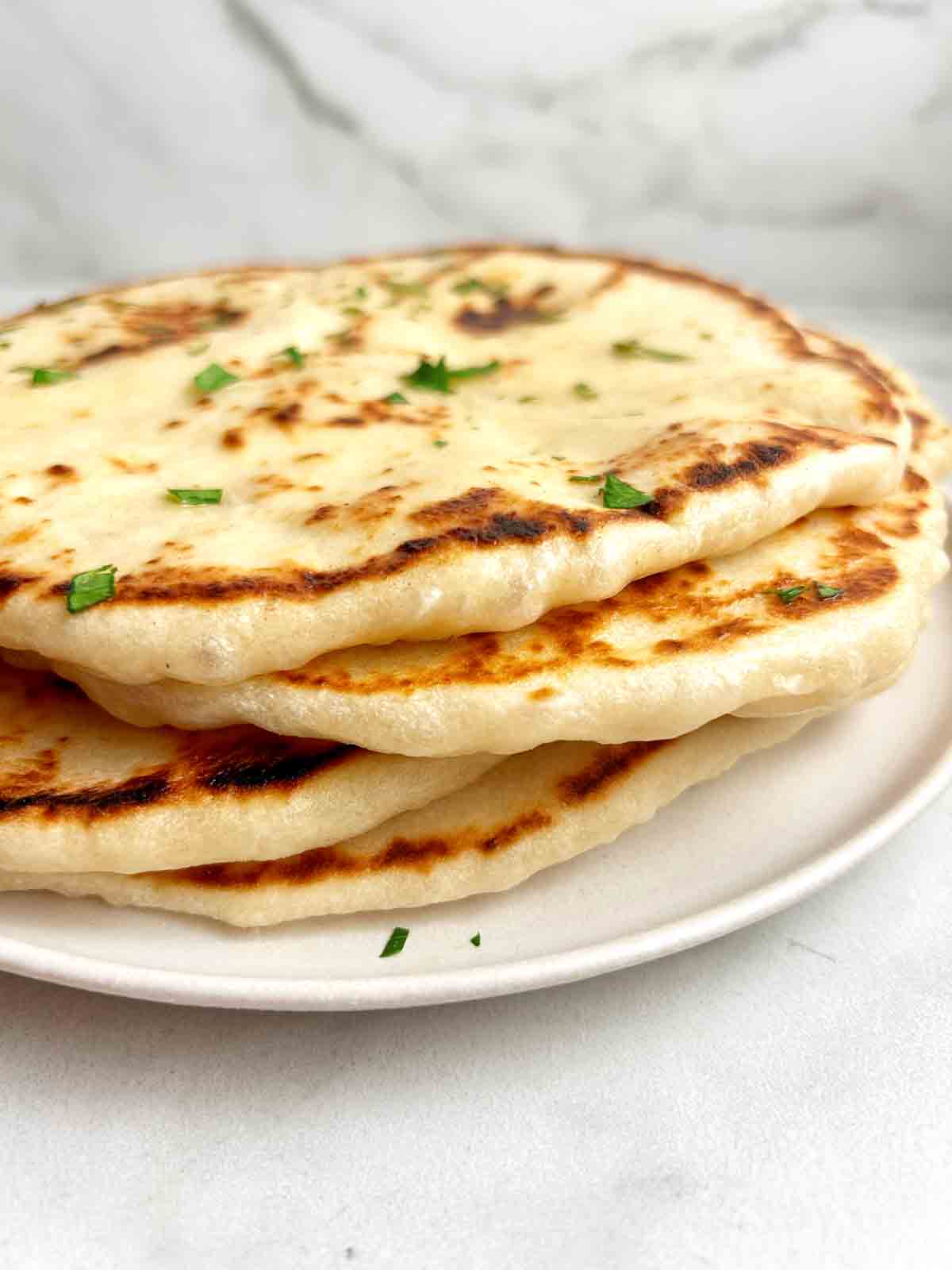 side view of stack of sourdough naan.