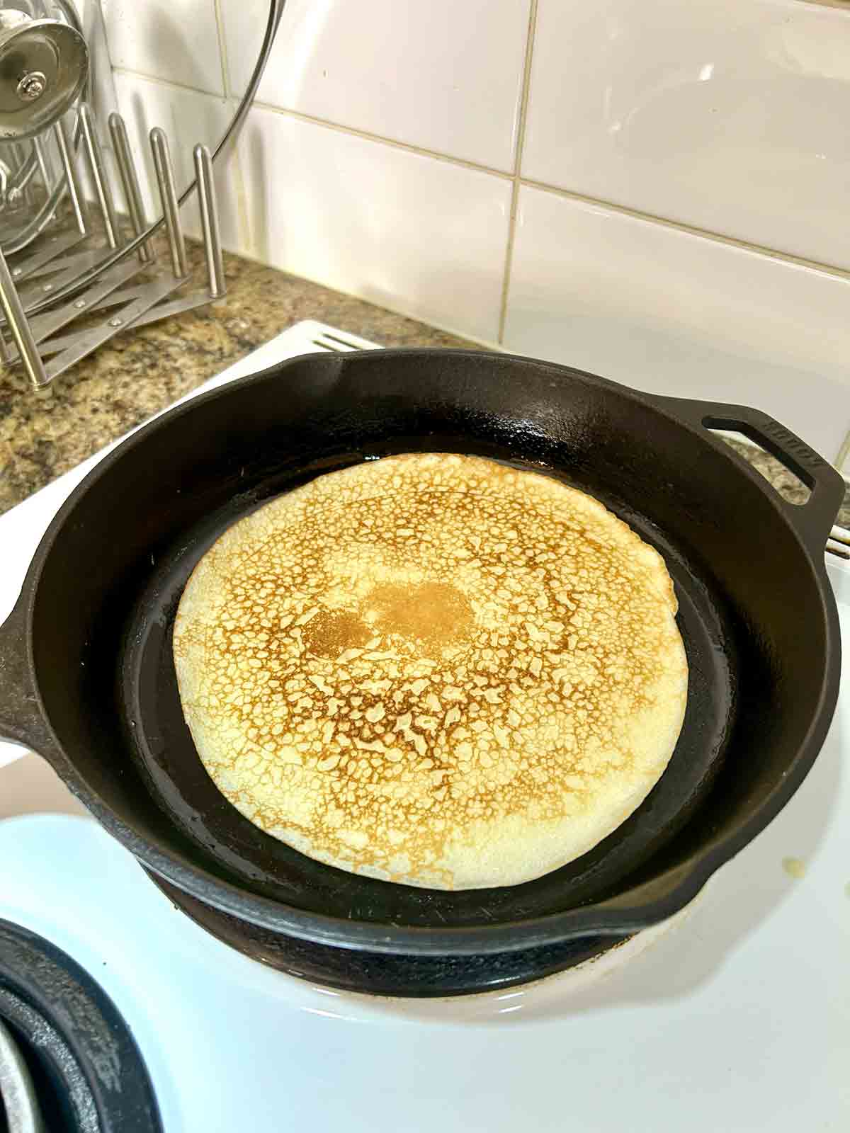 second side of pancake being cooked until golden brown.
