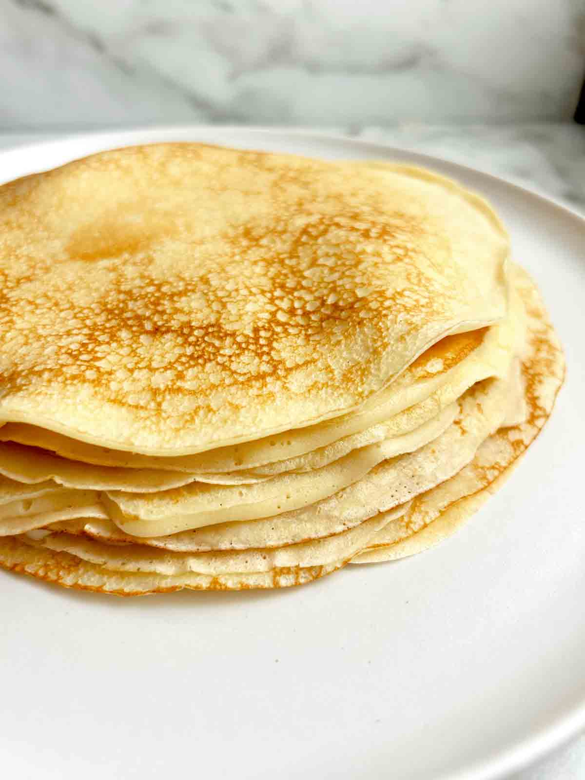 stack of Swedish pancakes on plate.