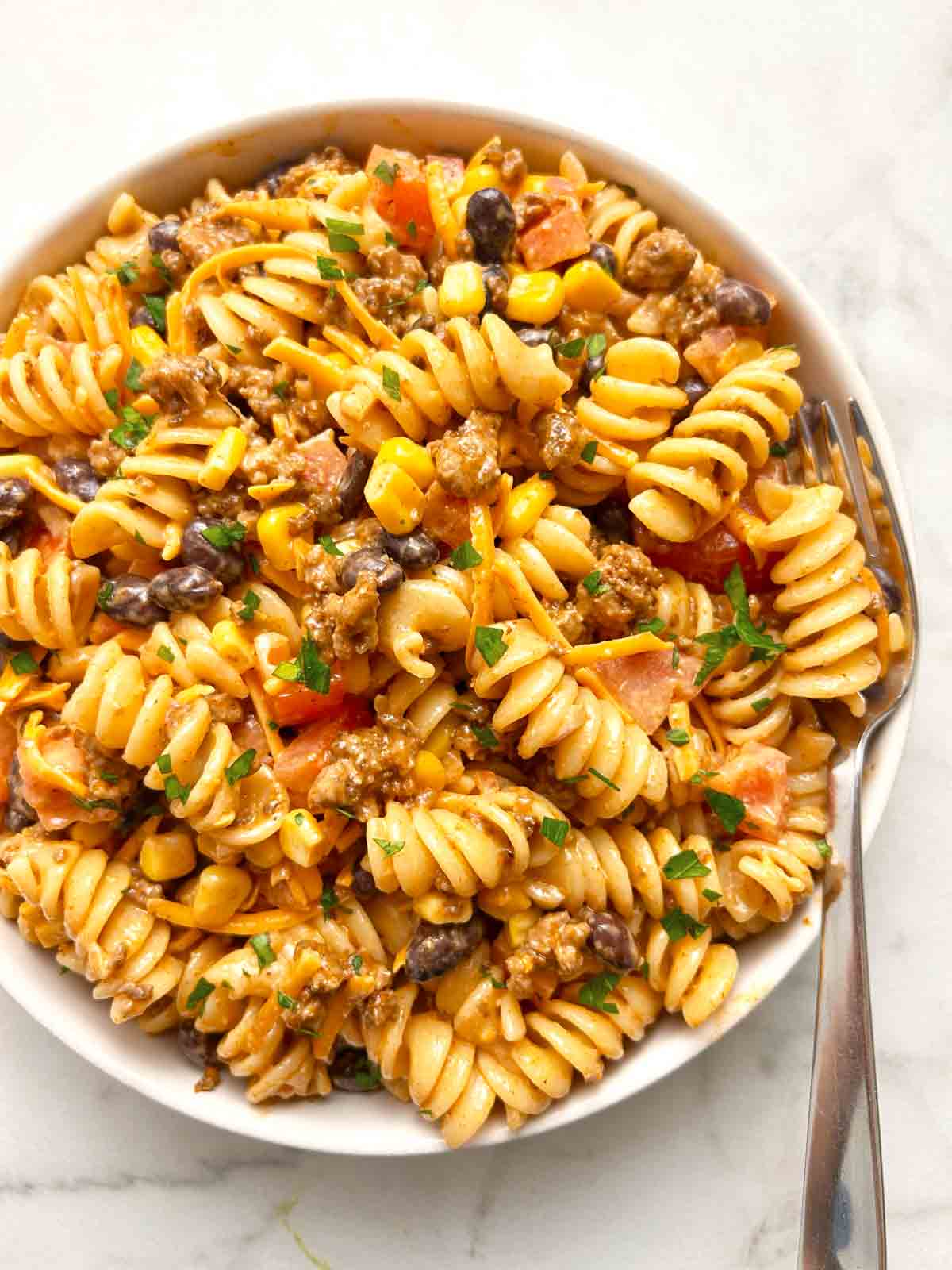 taco pasta salad in bowl with fork.