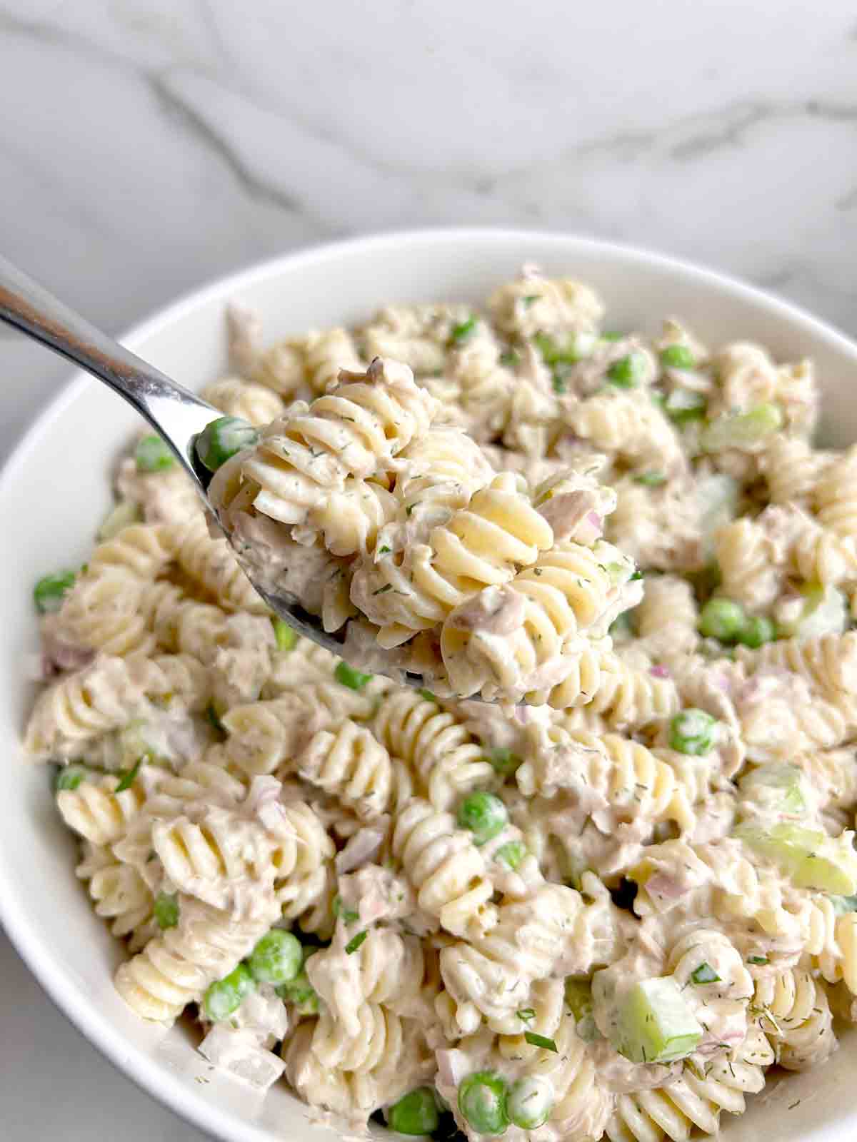 fork lifting pasta salad from bowl.