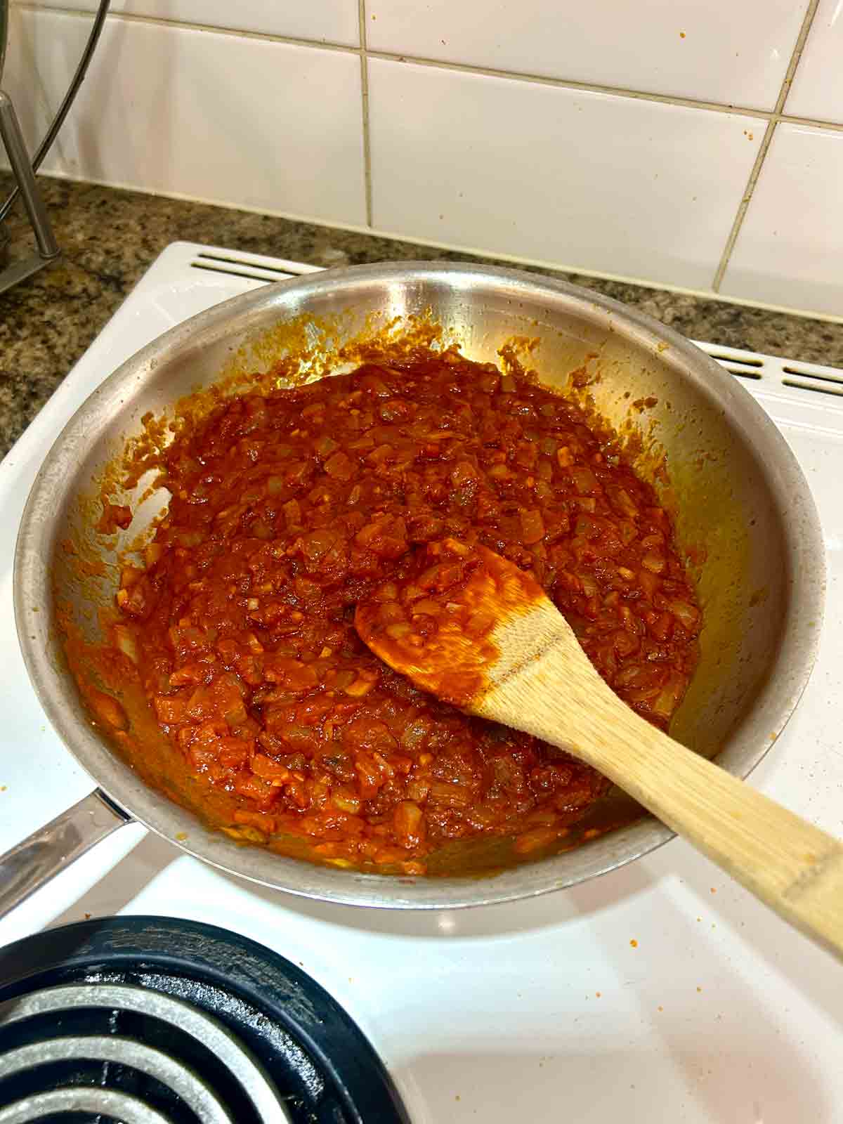 tomato paste stirred into onions and garlic.