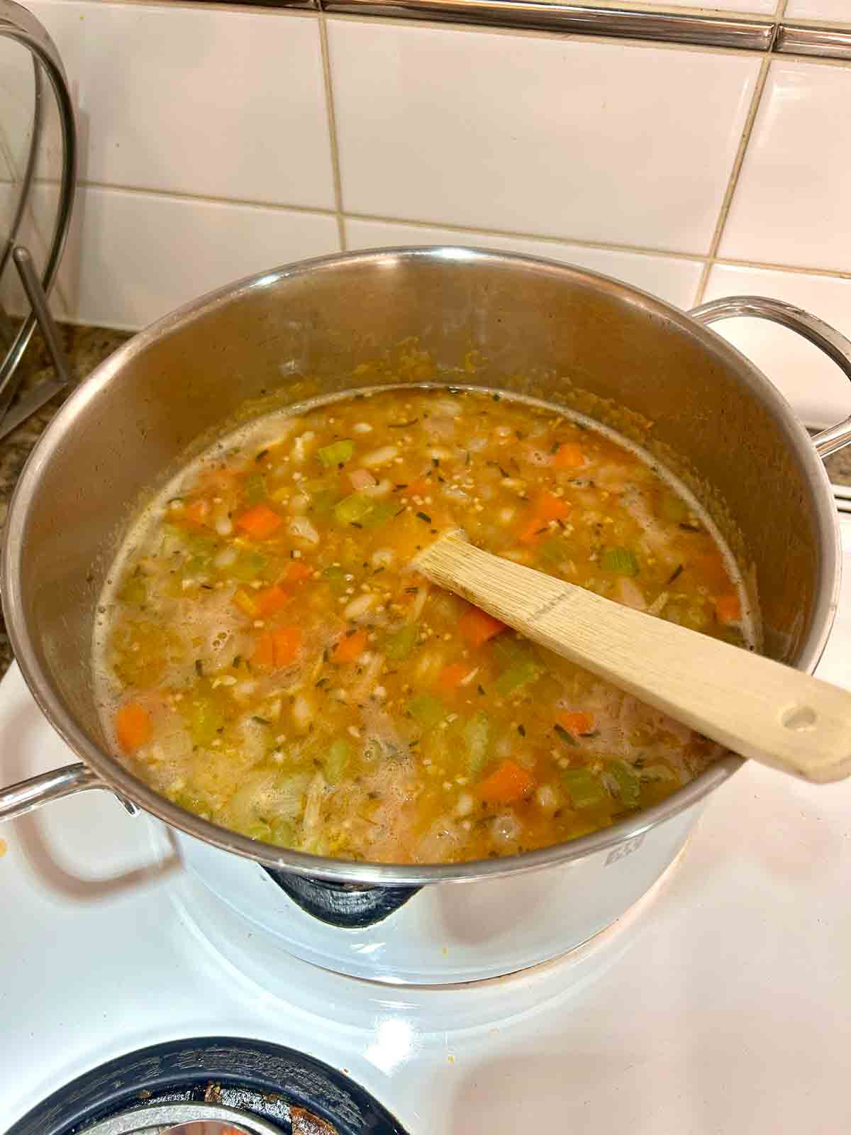 broth and other ingredients added to pot.