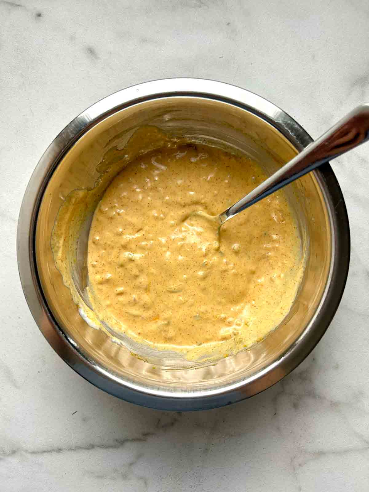 all ingredients mixed together in metal bowl.