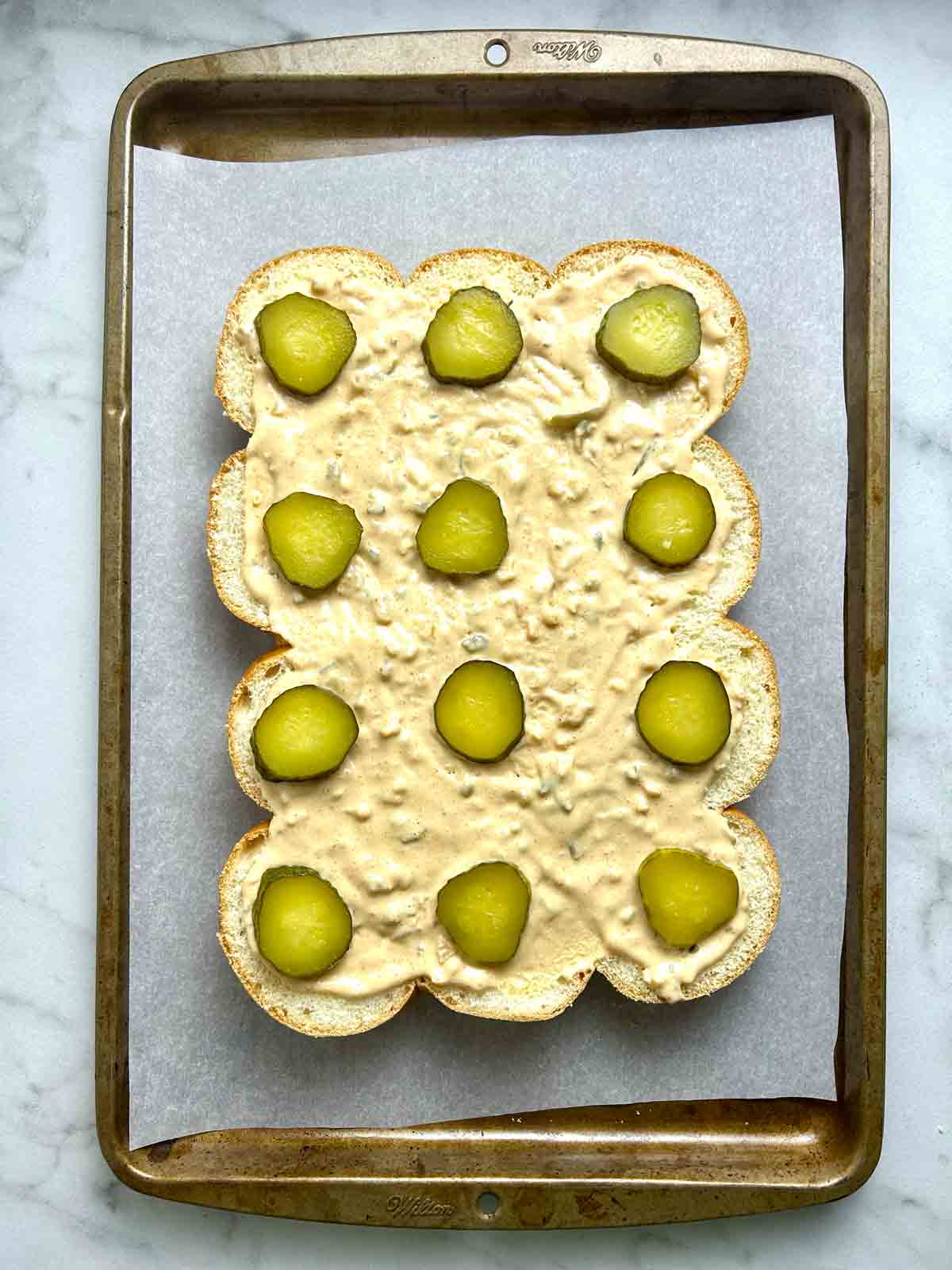 pickles and Big Mac sauce added to bottom slider buns.