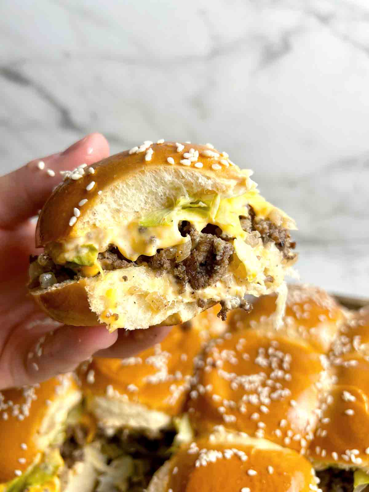 hand holding up Big Mac slider.