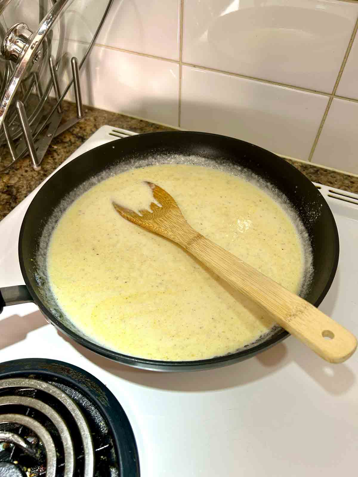 heavy cream and chicken broth added to skillet.