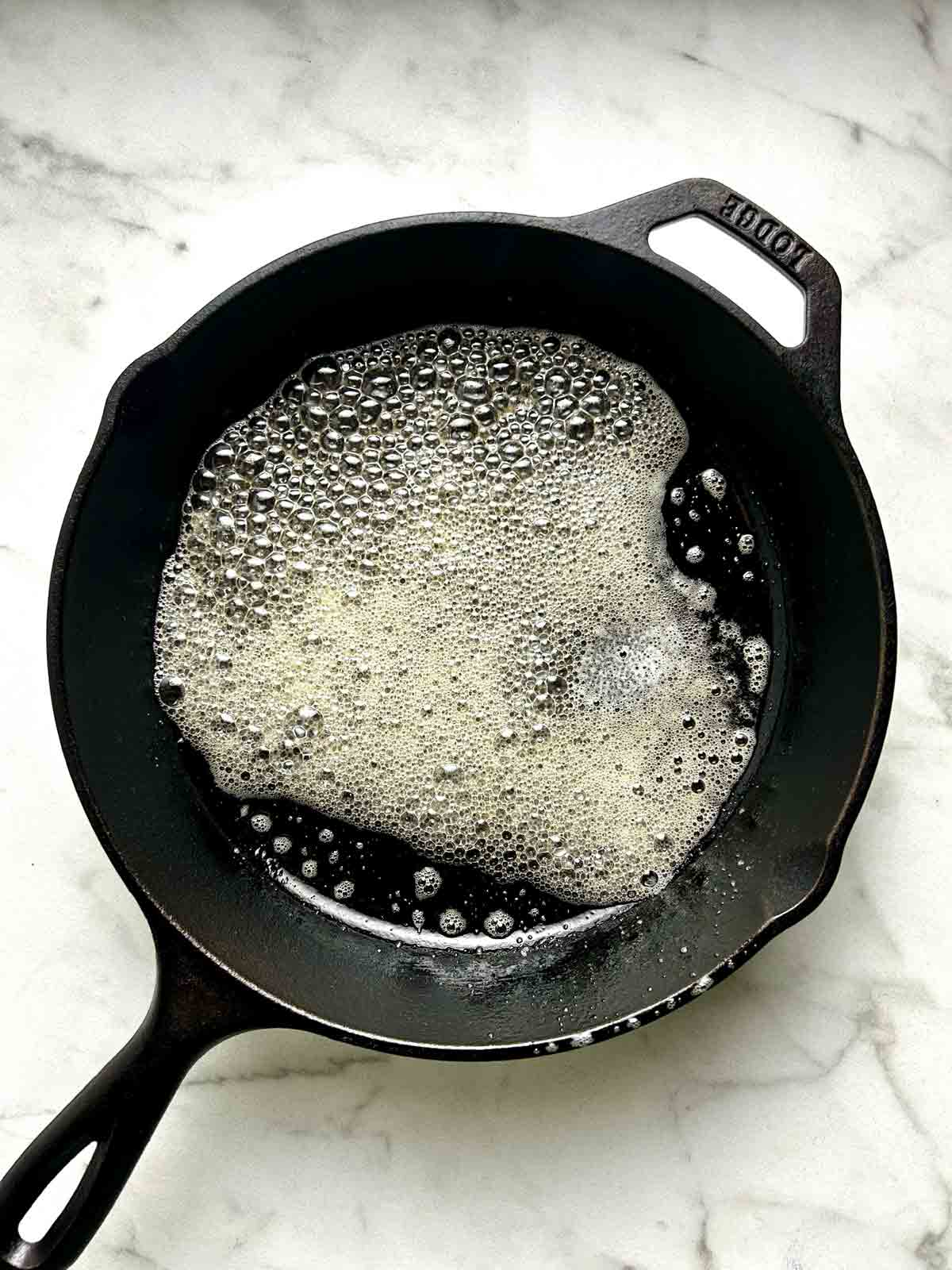 butter melted into cast iron skillet.