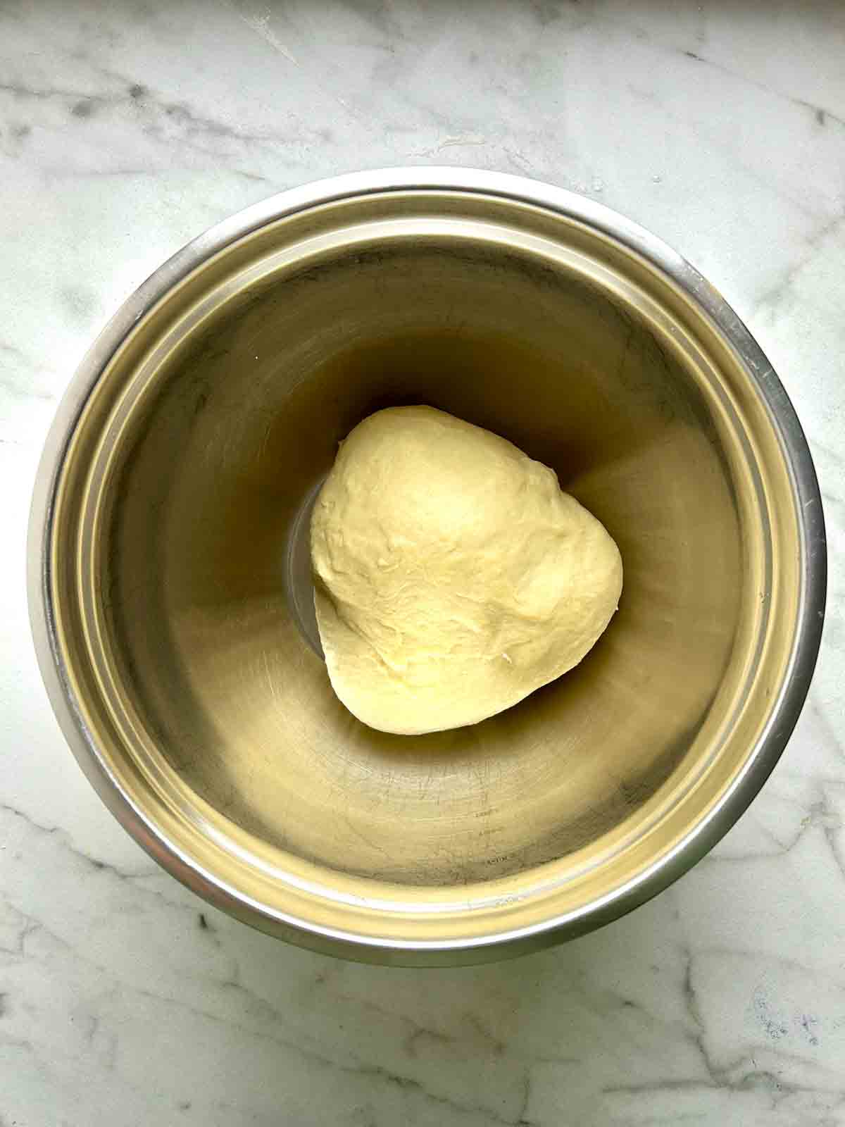 dough kneaded in bowl.