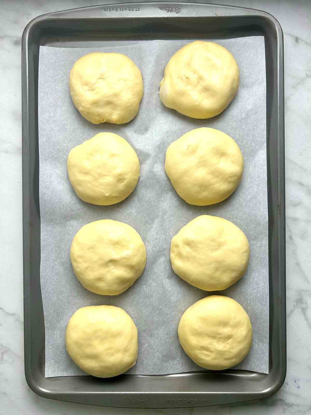 dough shaped on baking sheet.
